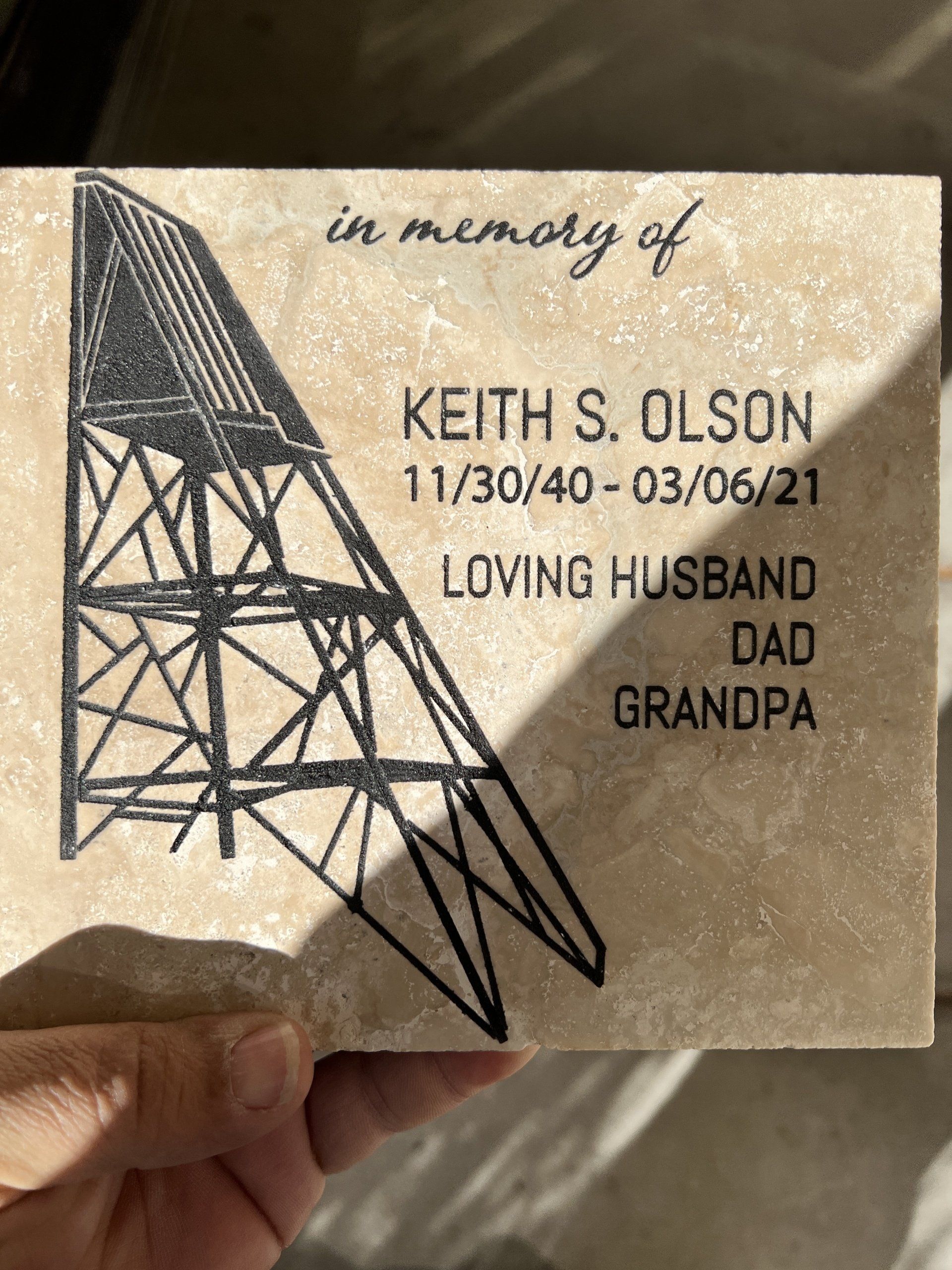 A person is holding a card in memory of keith s. olson