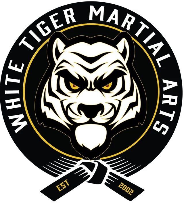 The logo for white tiger martial arts shows a tiger with a black belt around its neck.