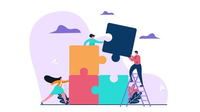 A group of people are putting puzzle pieces together.