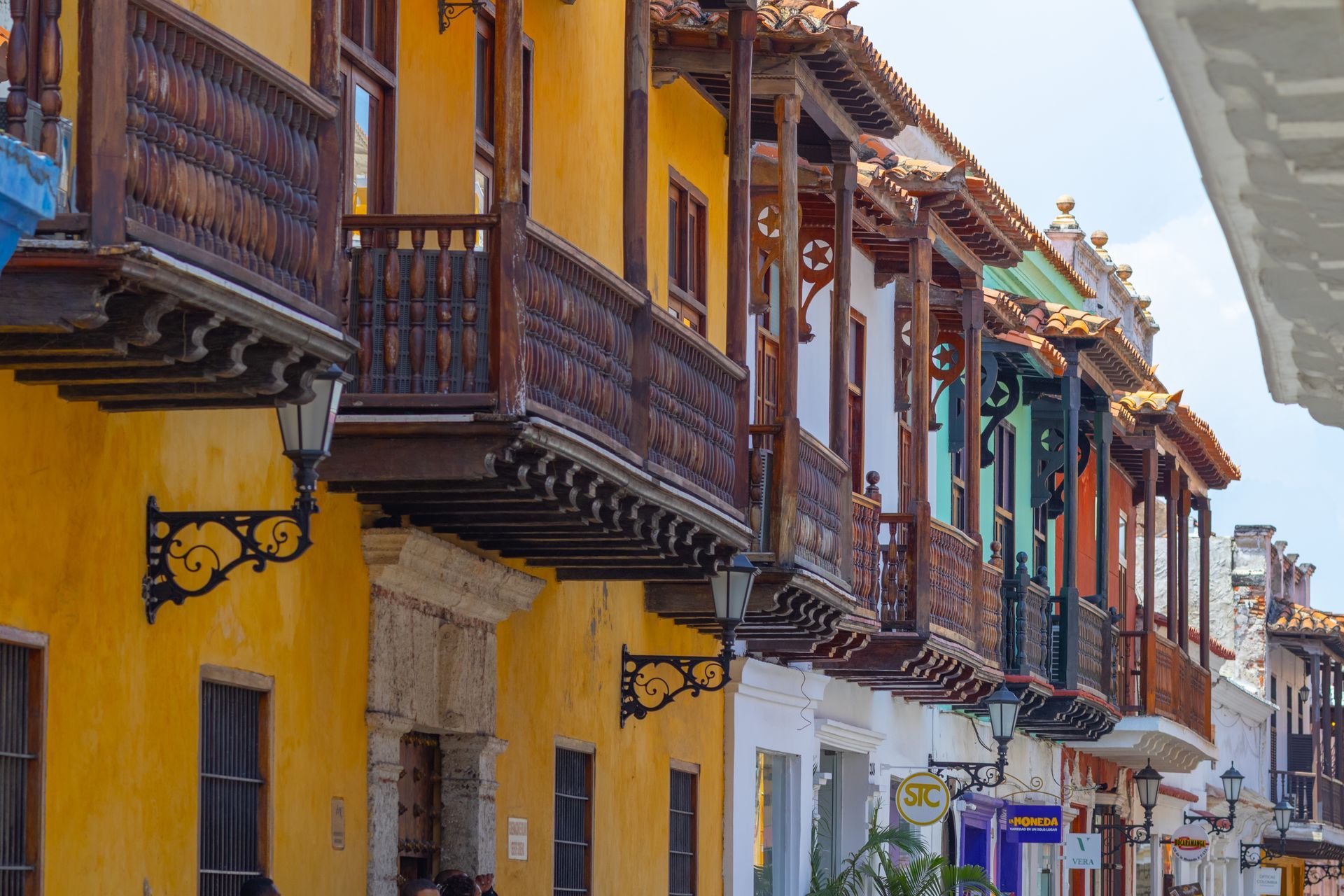 Row of colorful colonial buildings with wooden balconies in Cartagena, Colombia.