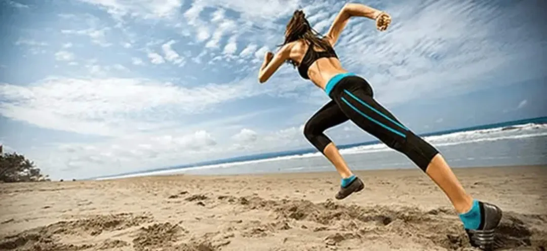 A woman is running on the beach.