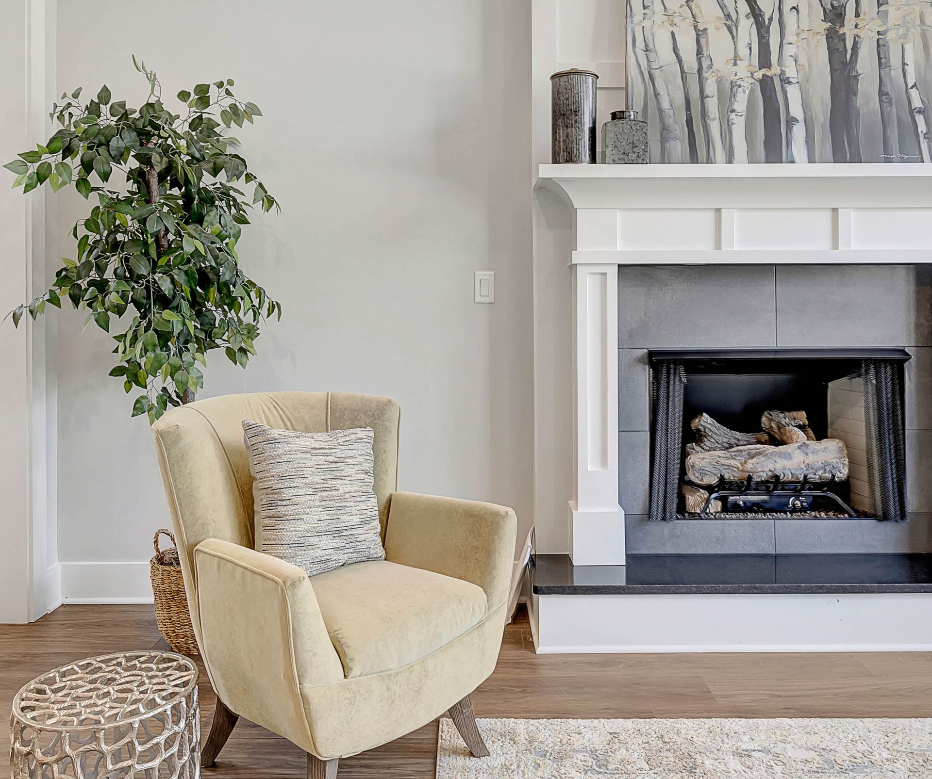 A living room with a fireplace and a chair.