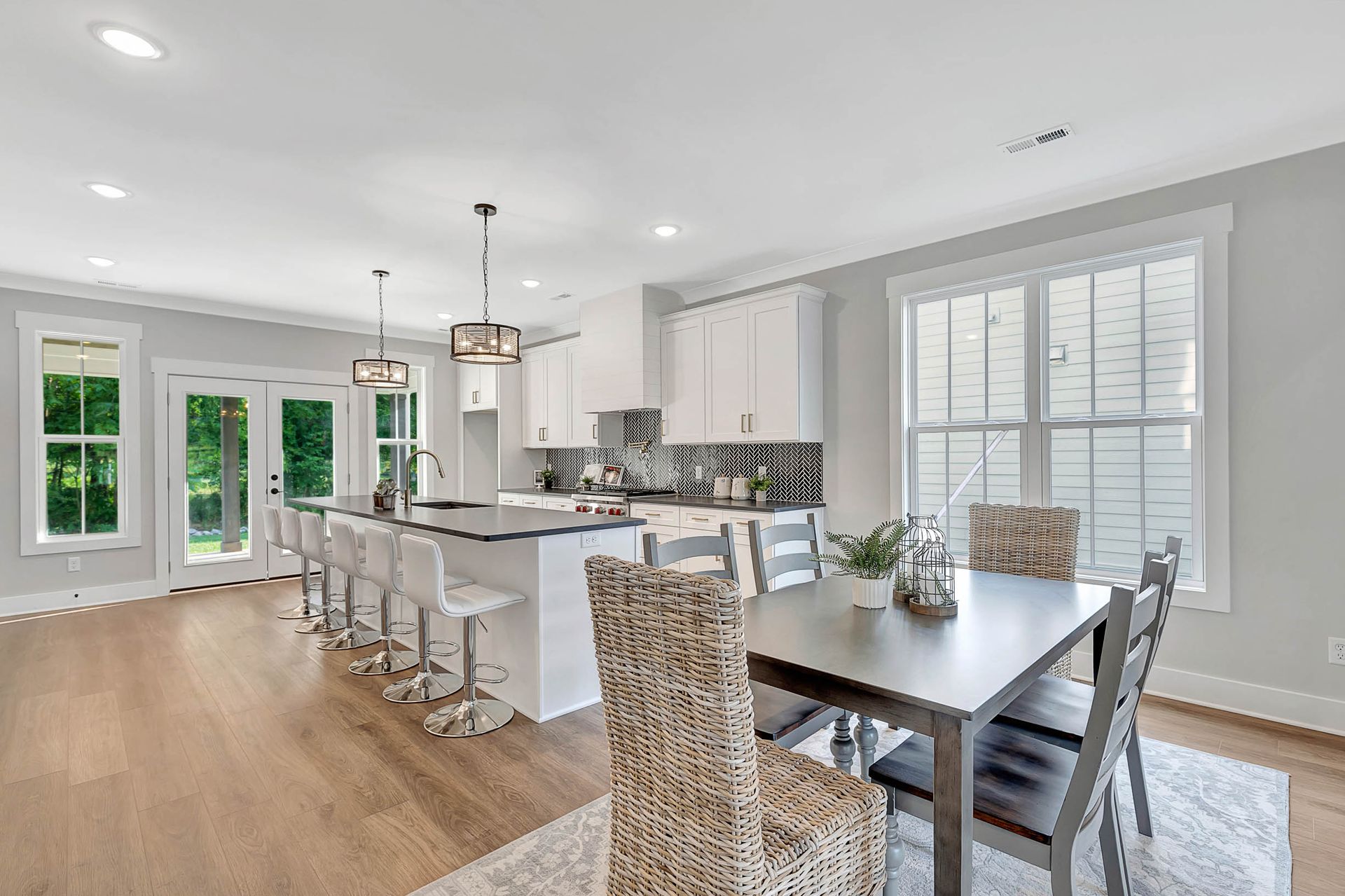 A kitchen and dining room in a house with a table and chairs.