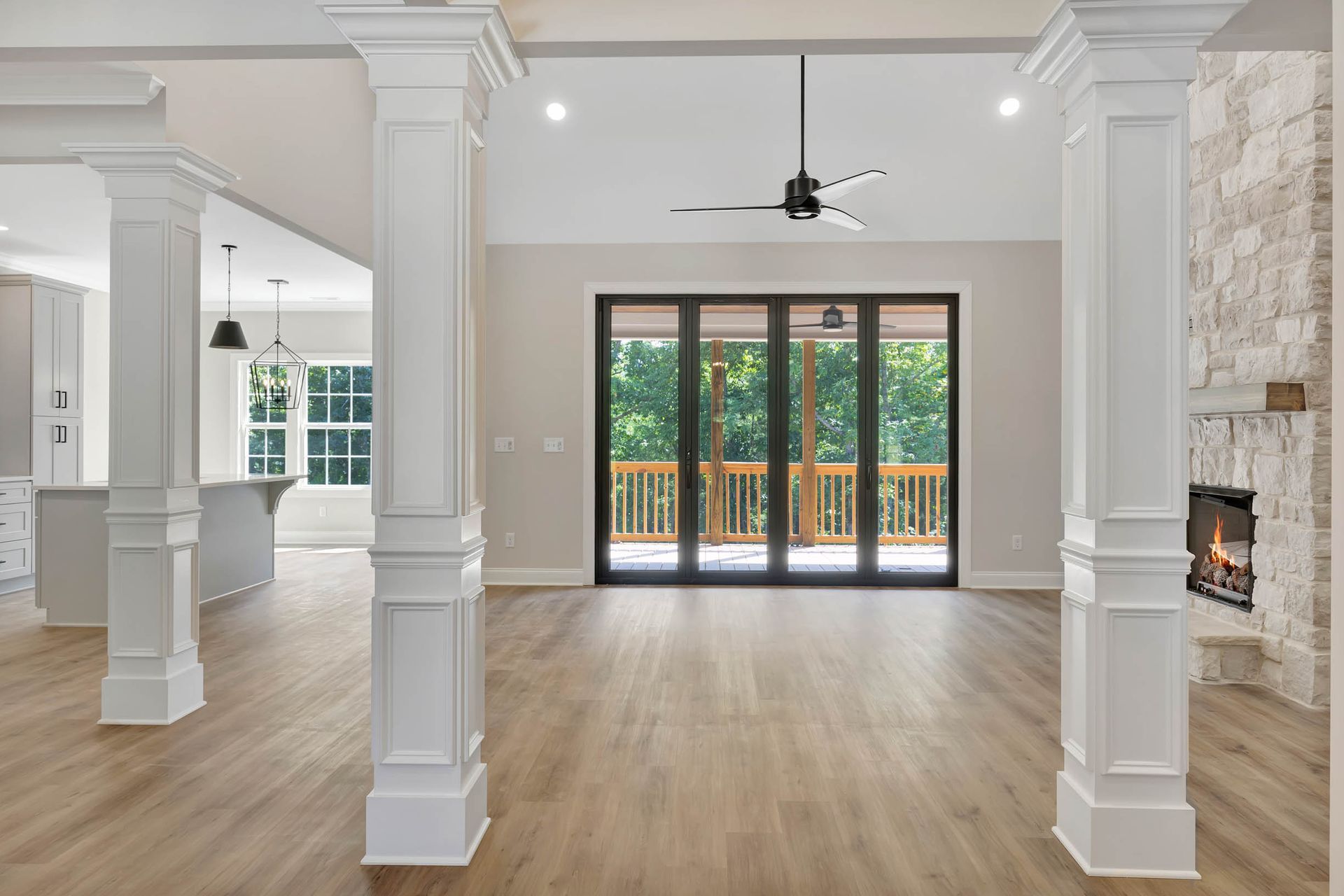 An empty living room with hardwood floors and a fireplace.