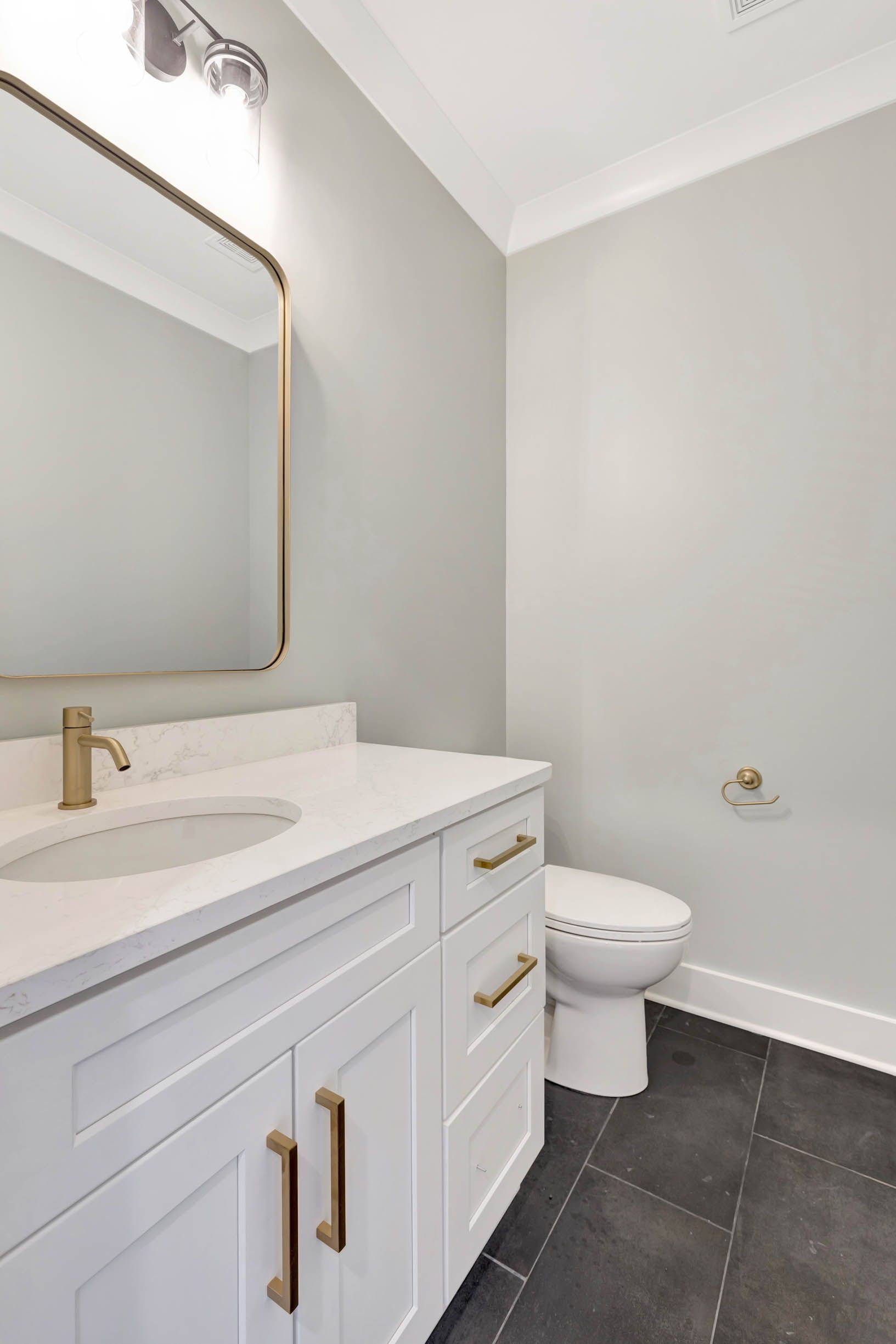 A bathroom with a sink , toilet and mirror.