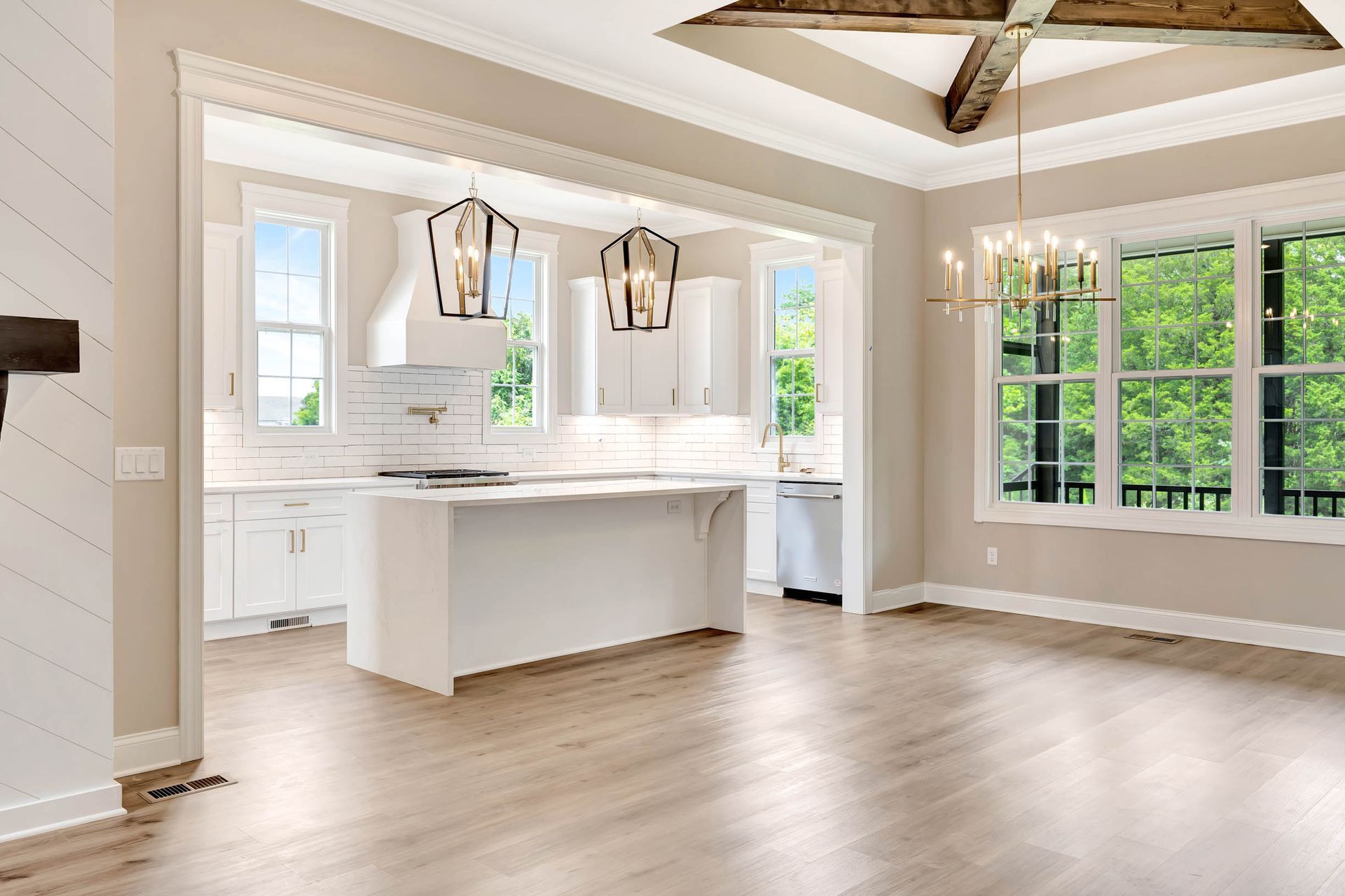 An empty kitchen with a large island in the middle of the room.