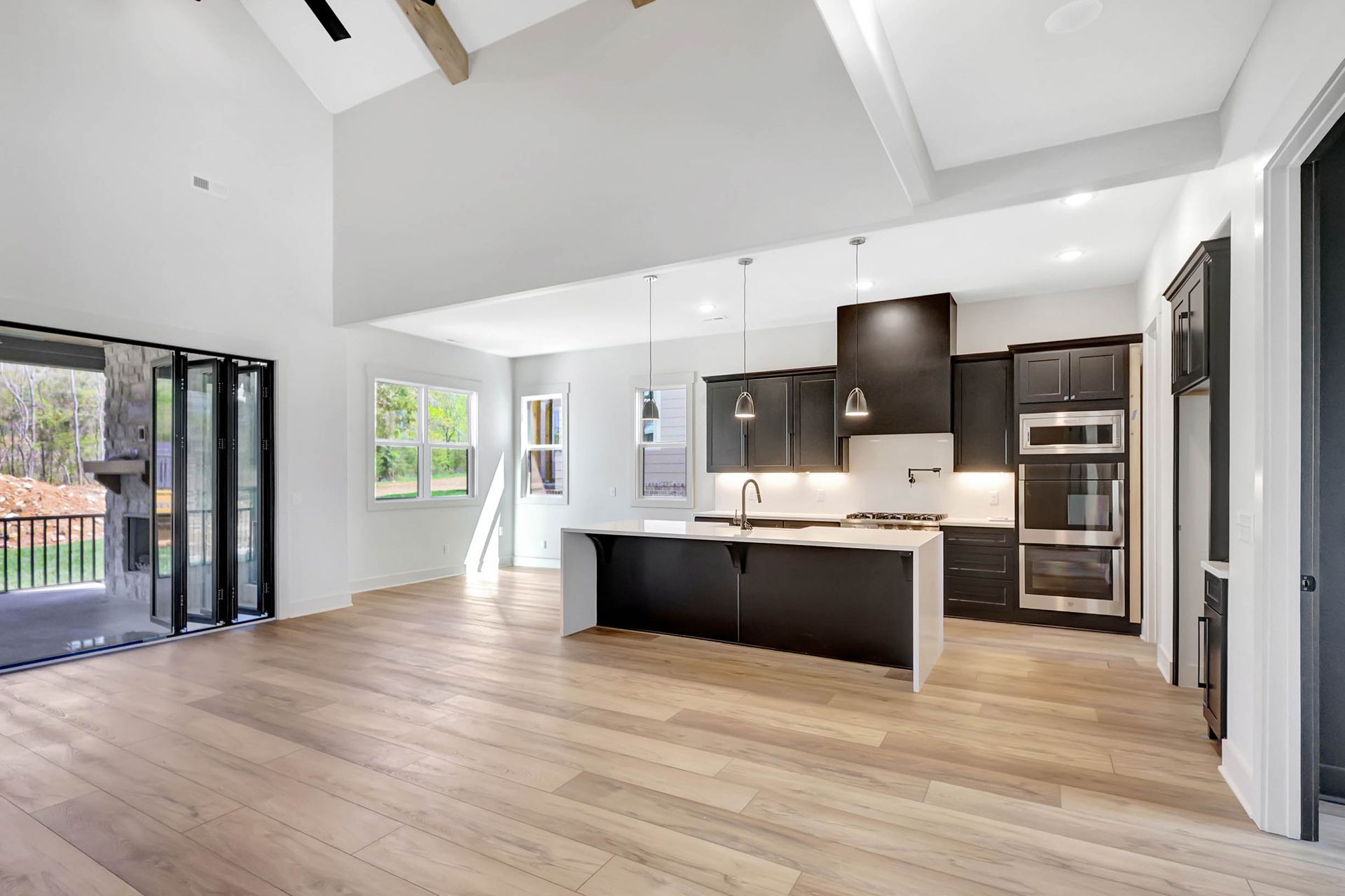 An empty kitchen with a large island in the middle of the room.