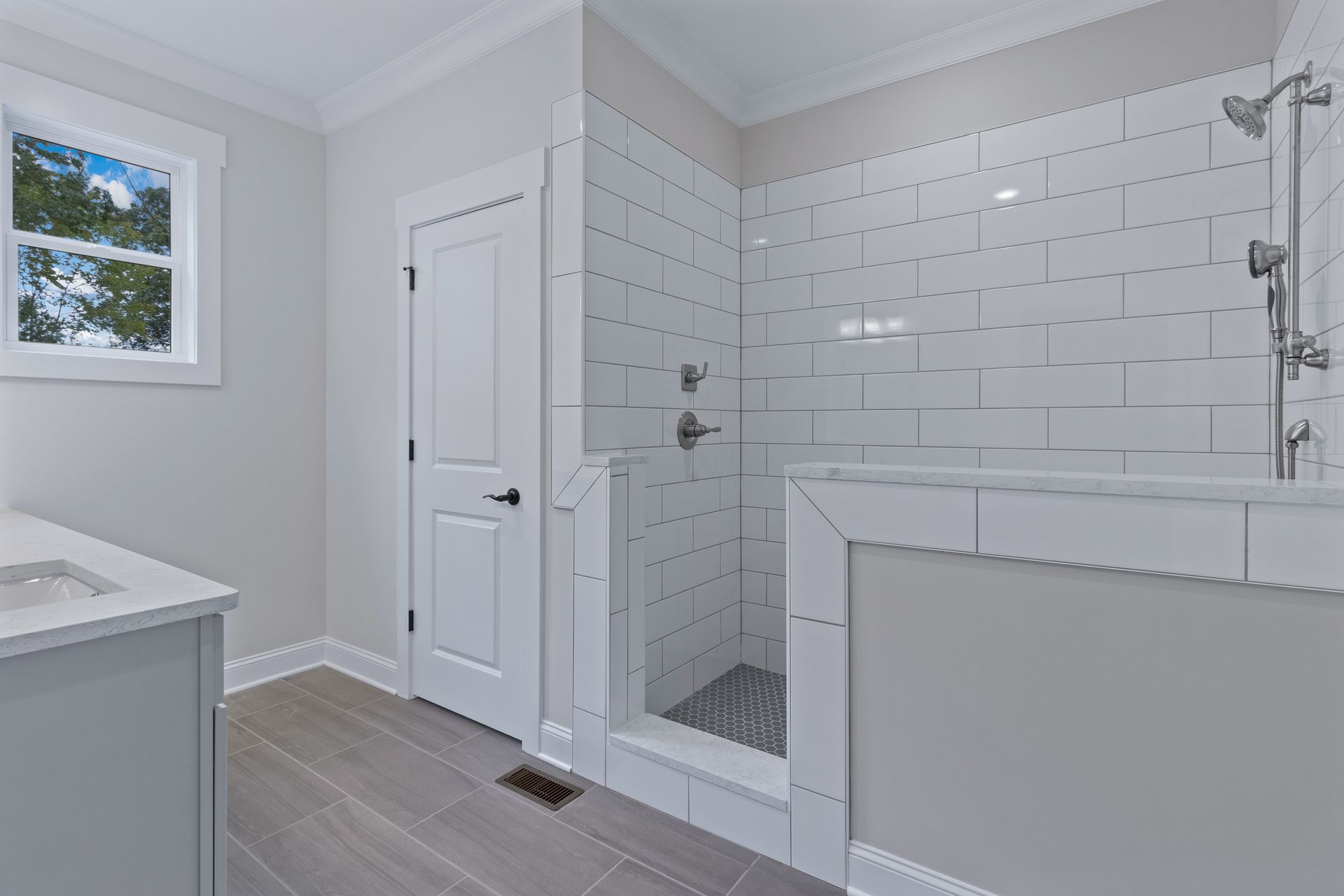 a bathroom with a walk in shower and a sink .