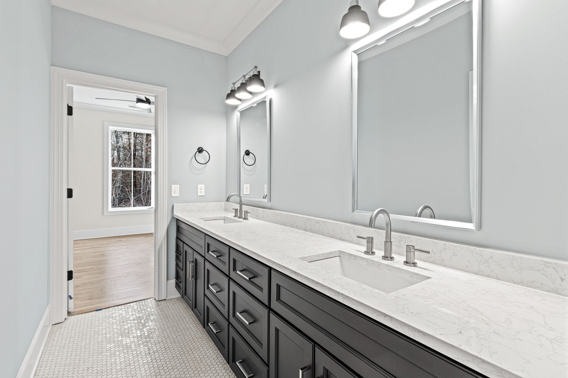 a bathroom with two sinks and two mirrors .
