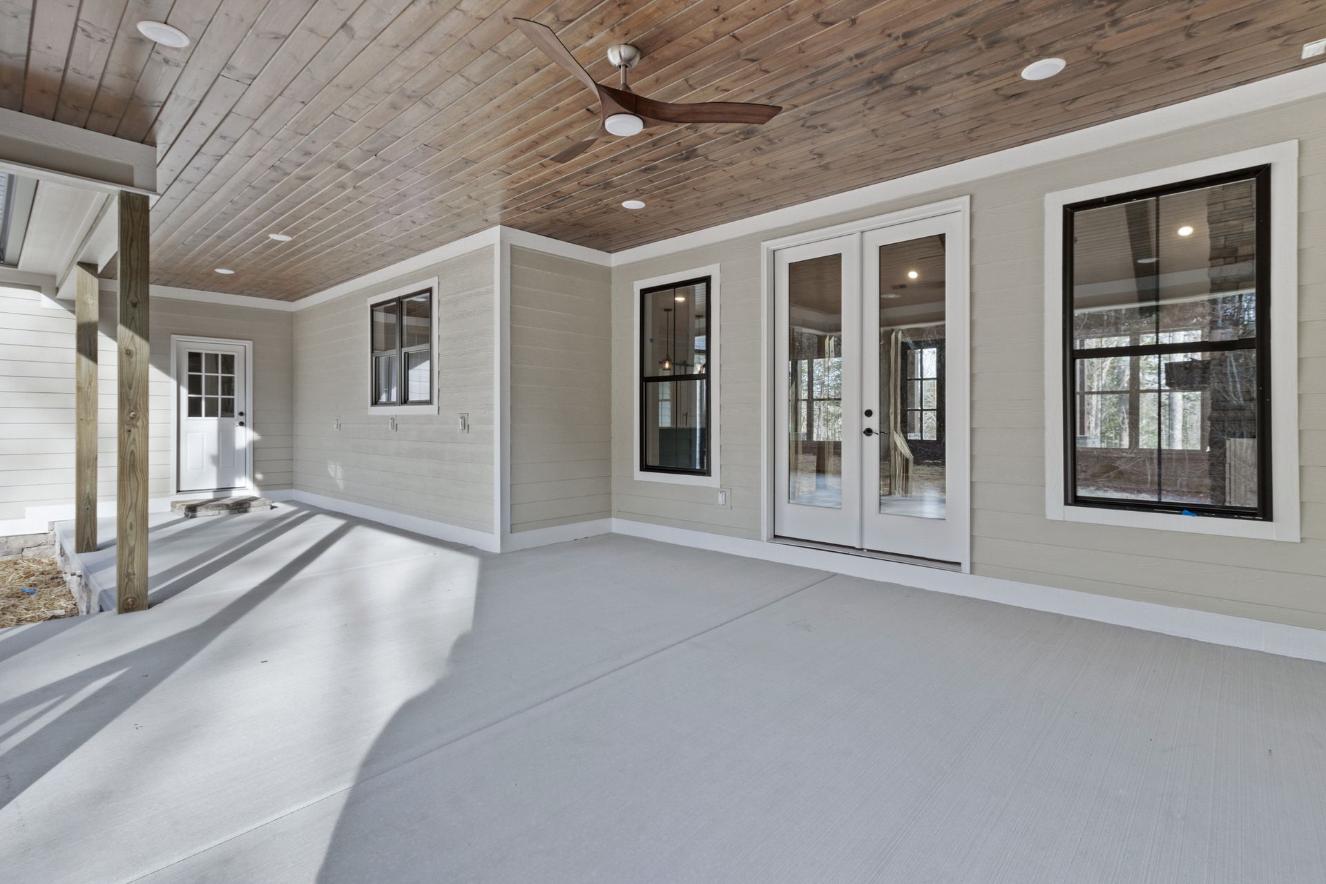 there is a ceiling fan on the porch of a house .