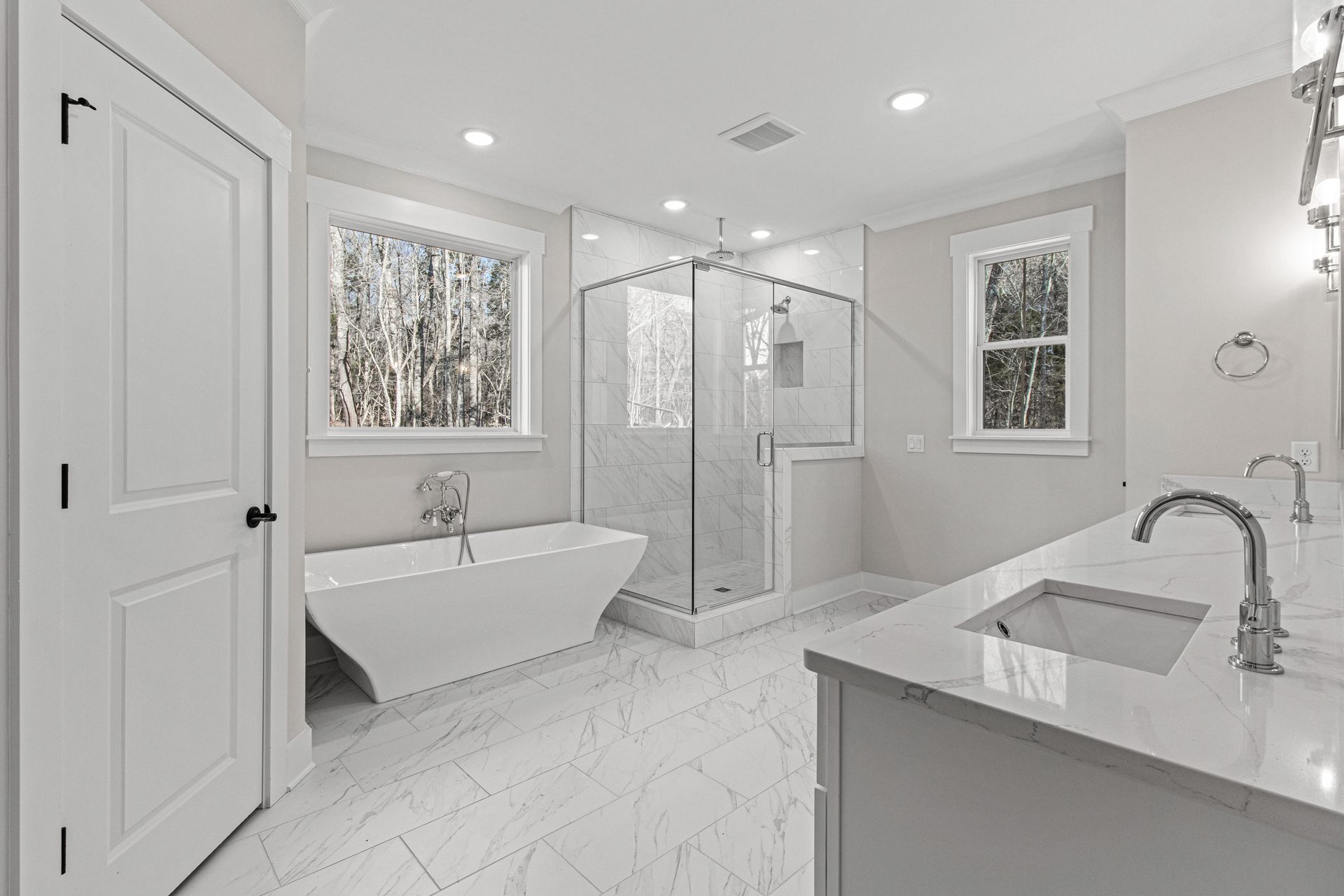 a bathroom with a tub , sink , and shower .