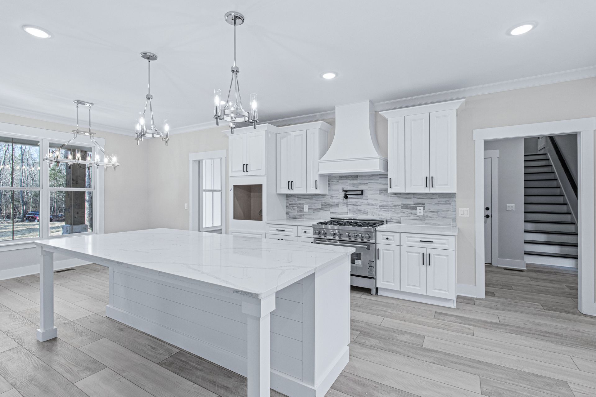 there is a large island in the middle of the kitchen .