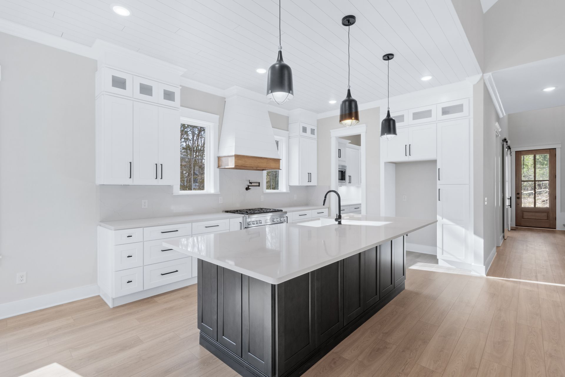 there is a large island in the middle of the kitchen .