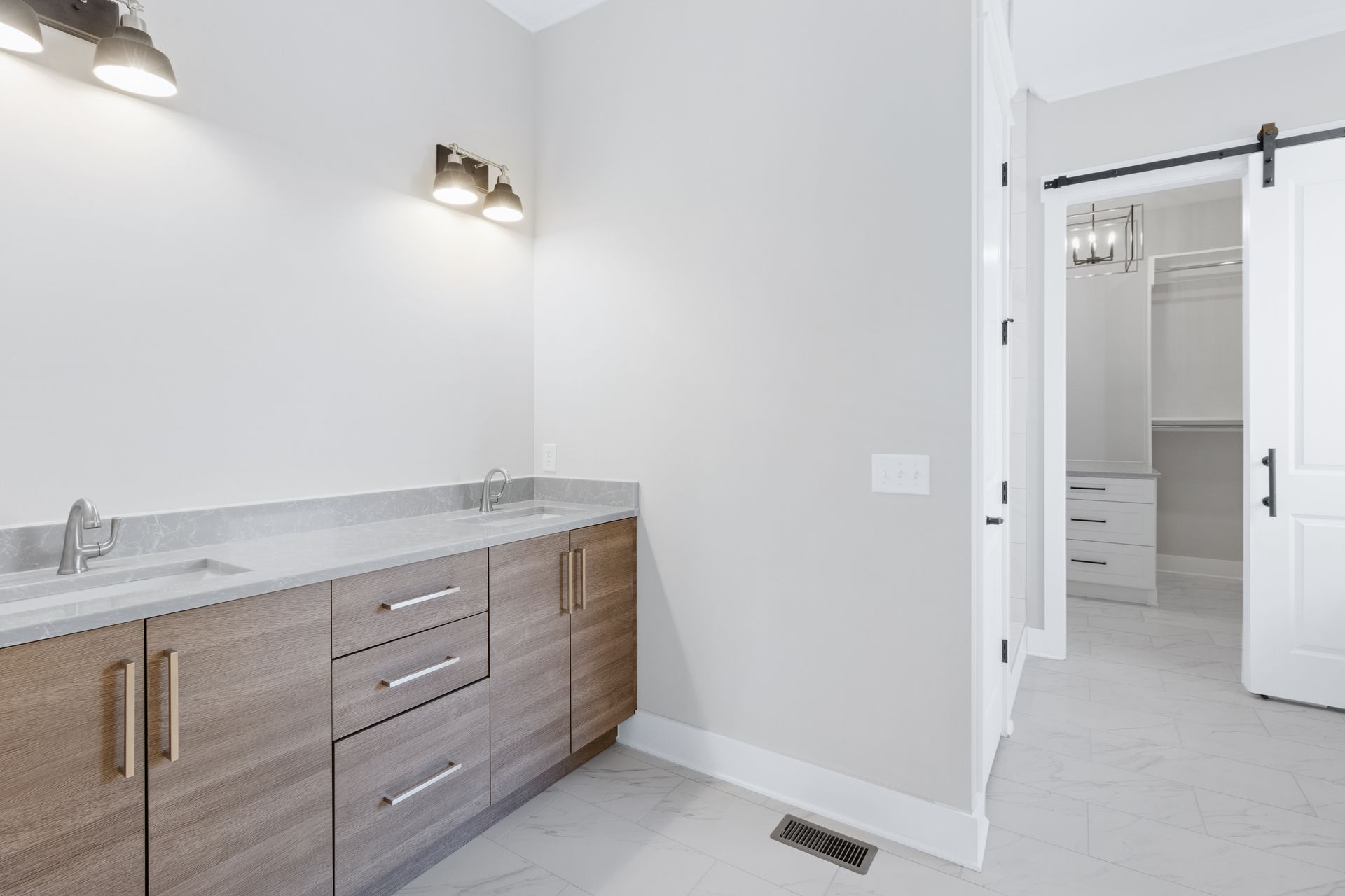 a bathroom with two sinks and a walk in closet .