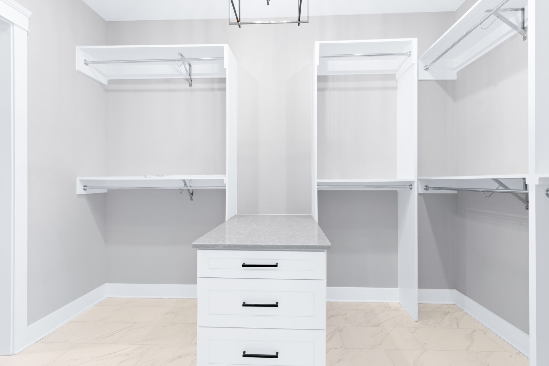 an empty walk in closet with lots of shelves and drawers .