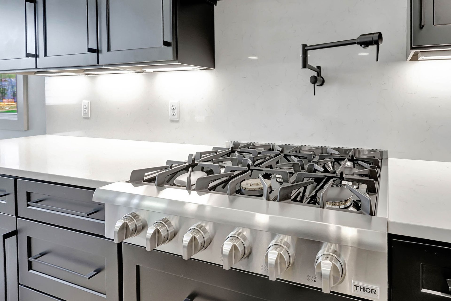 A stove top oven is sitting on top of a counter in a kitchen.