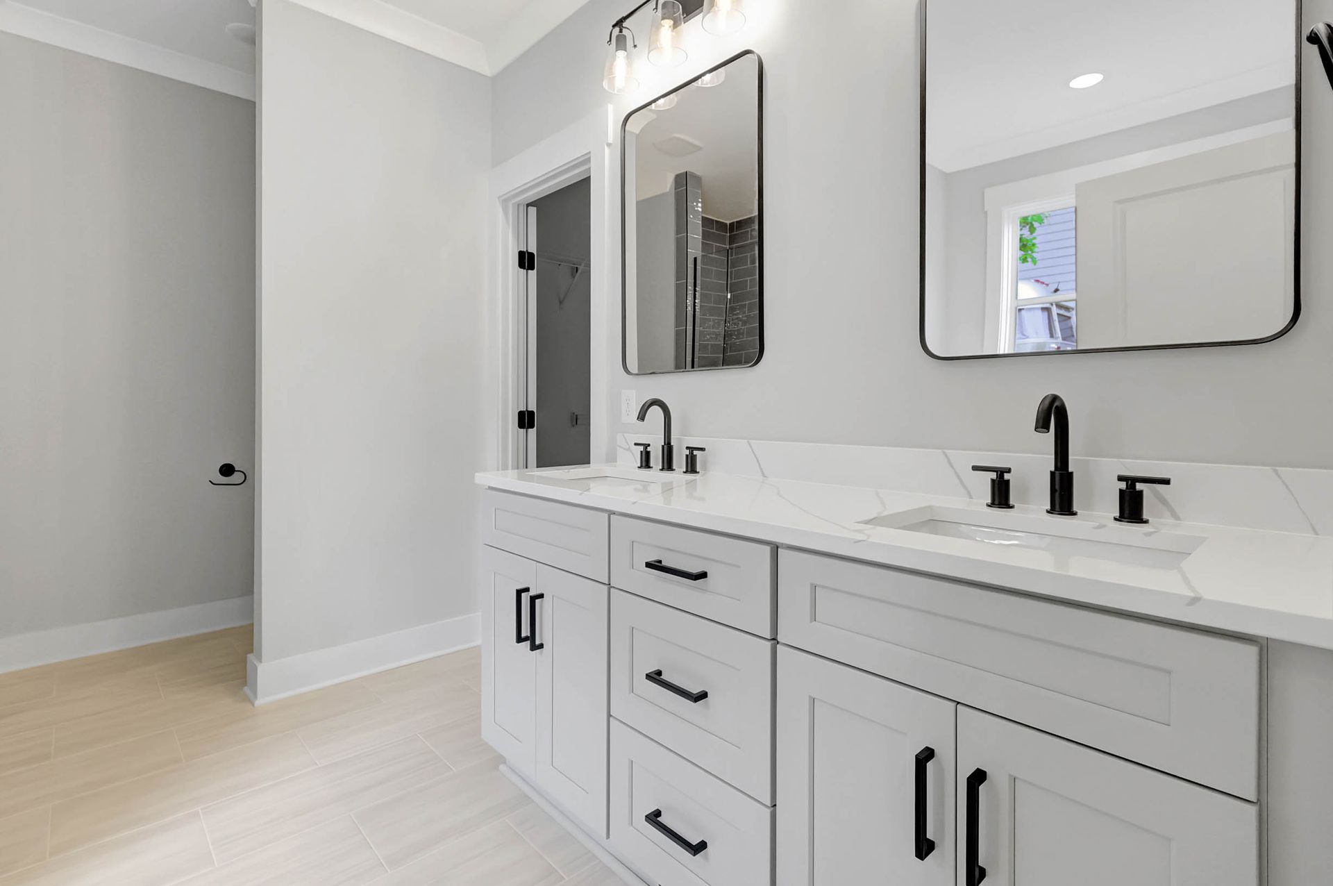 A bathroom with two sinks and two mirrors.