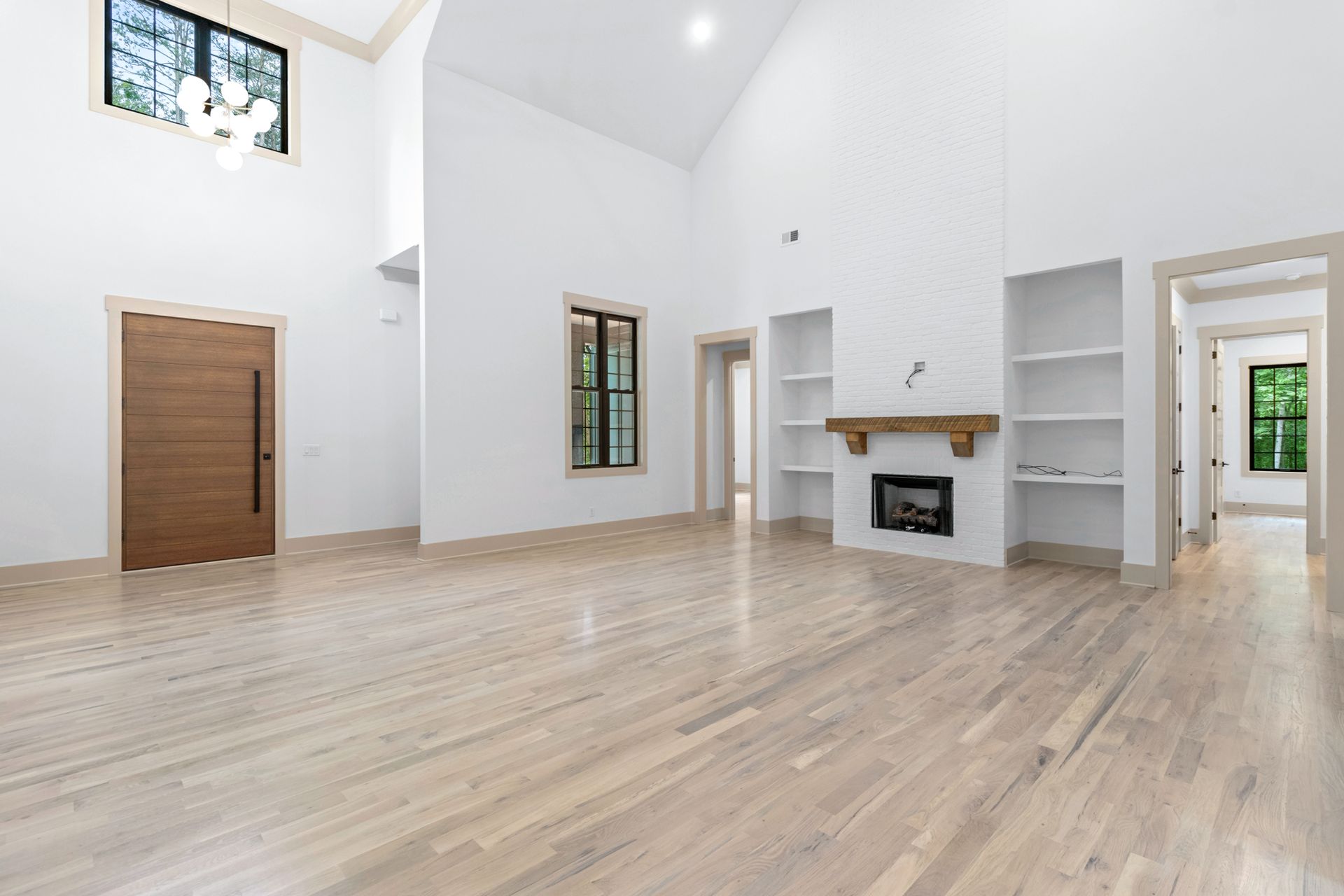 a bathroom with two sinks , two mirrors and a walk in closet .