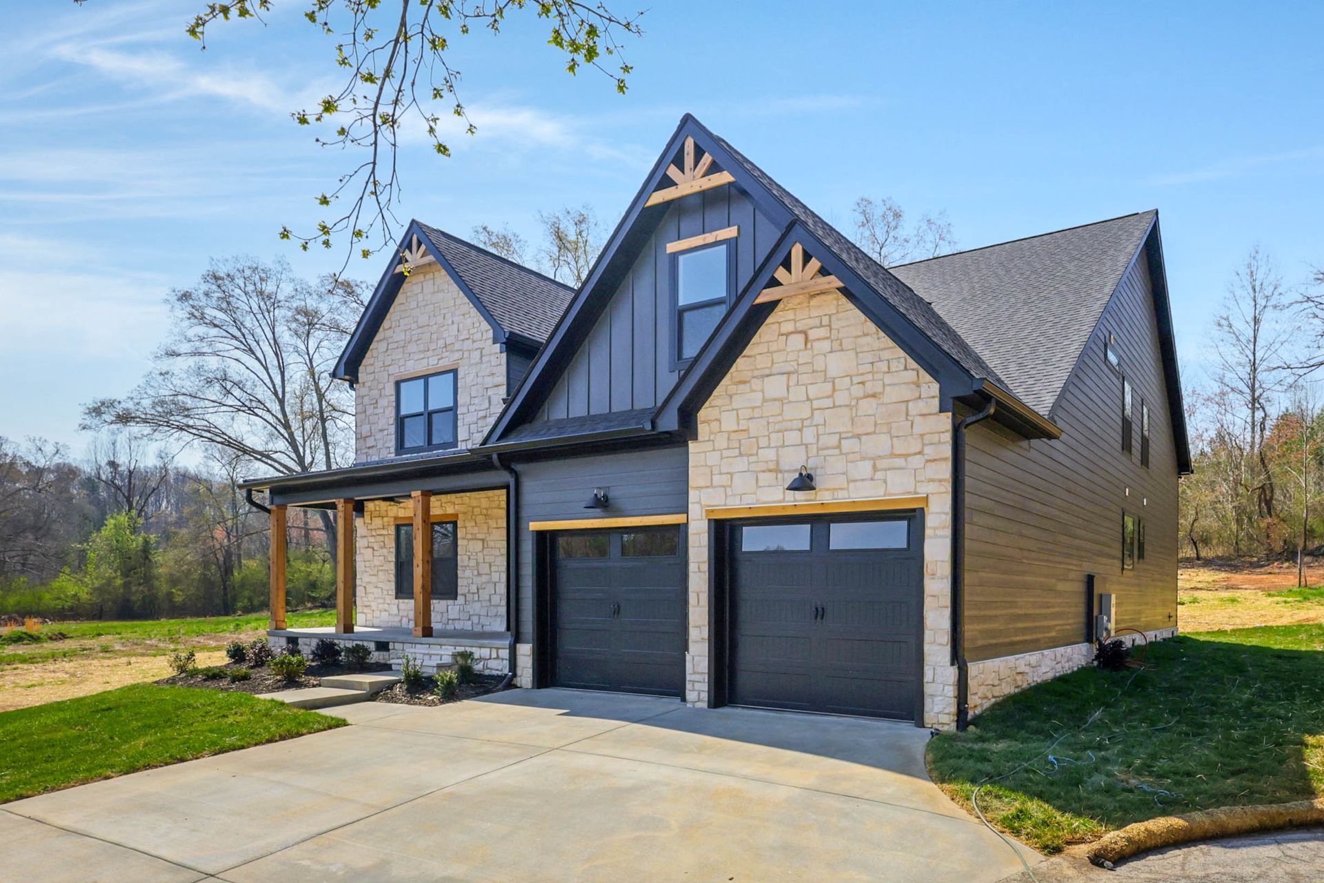 A large house with two garages and a driveway in front of it.