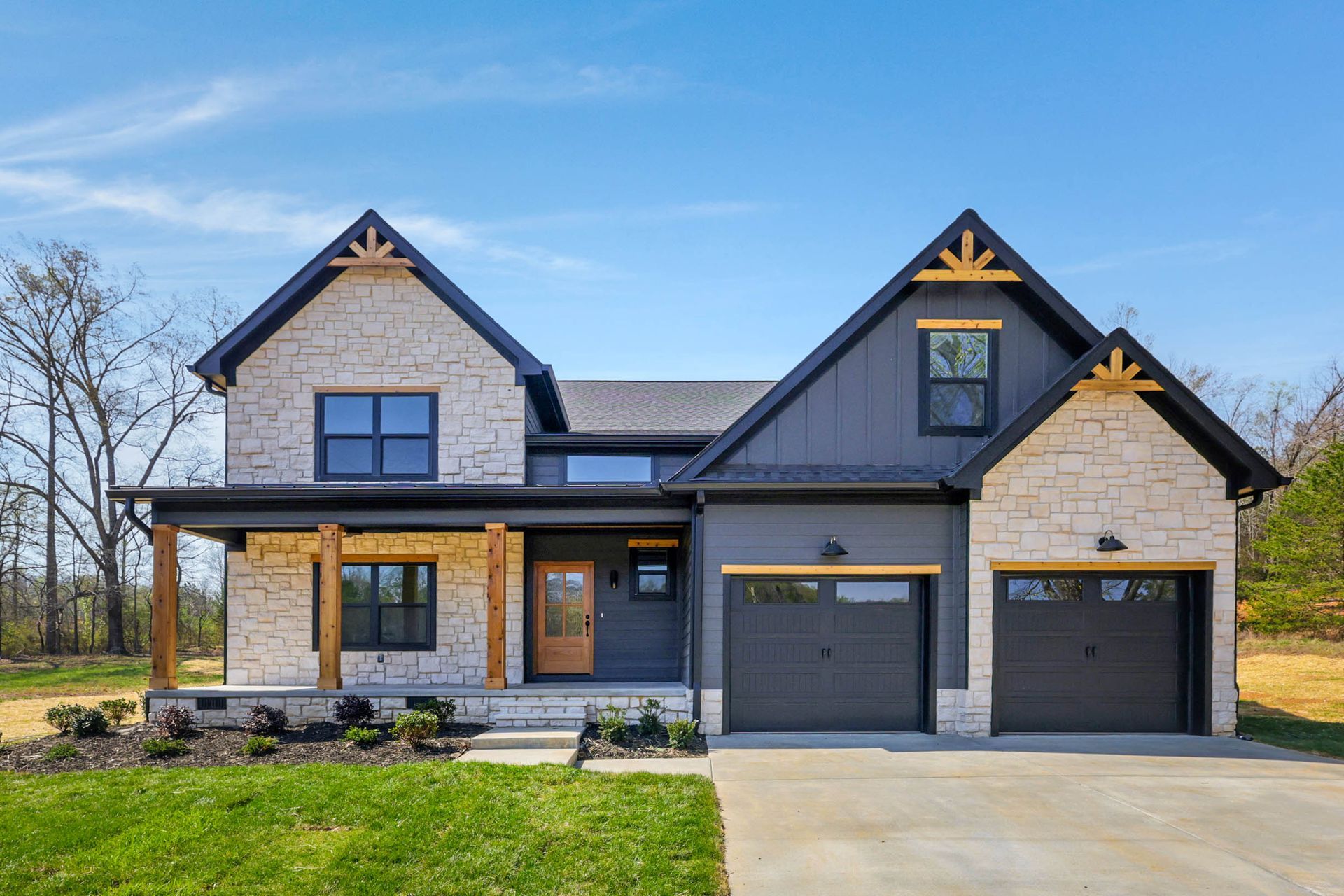 A large house with two garages and a porch.