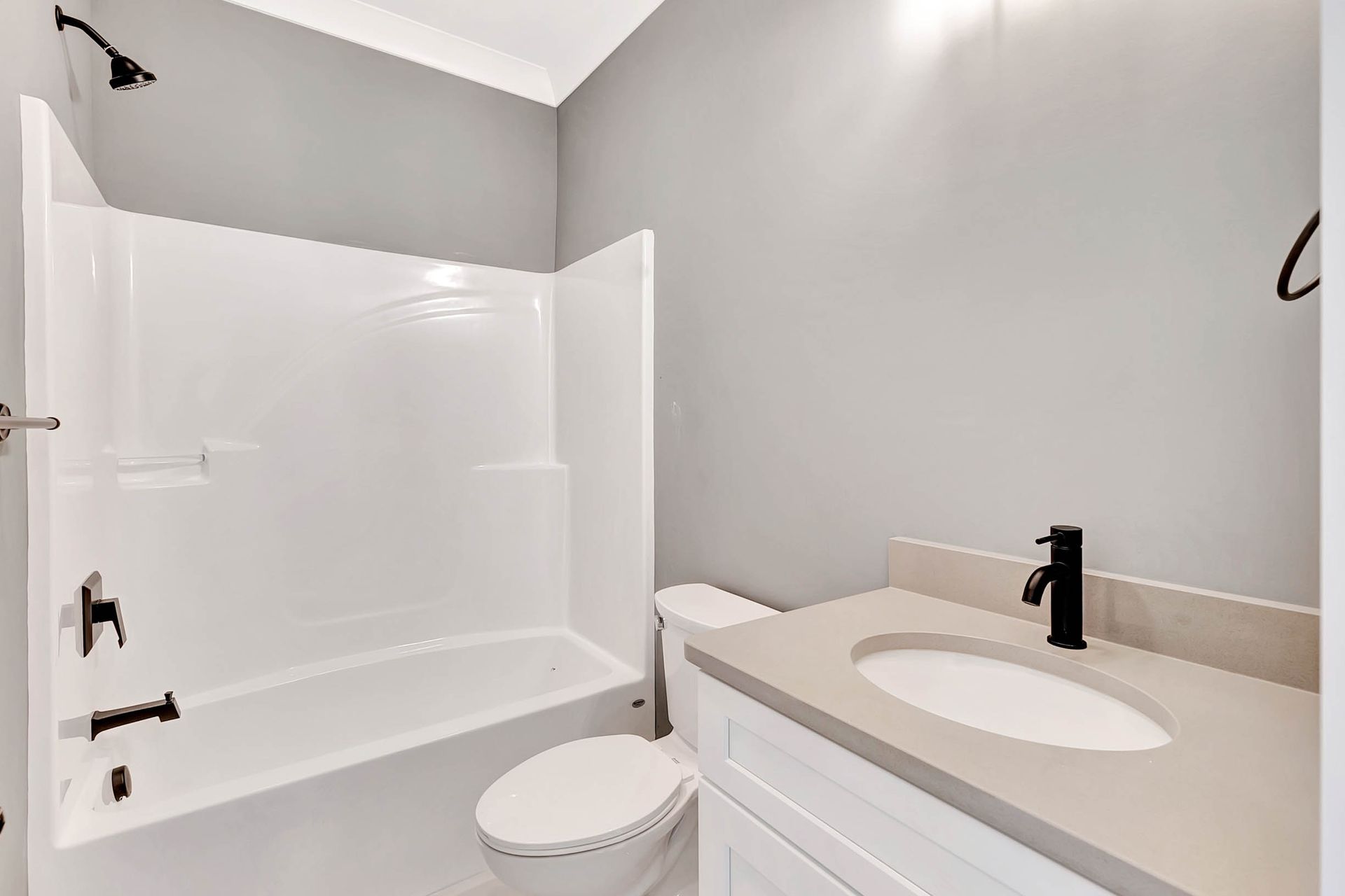 A bathroom with a toilet , sink , bathtub and shower.