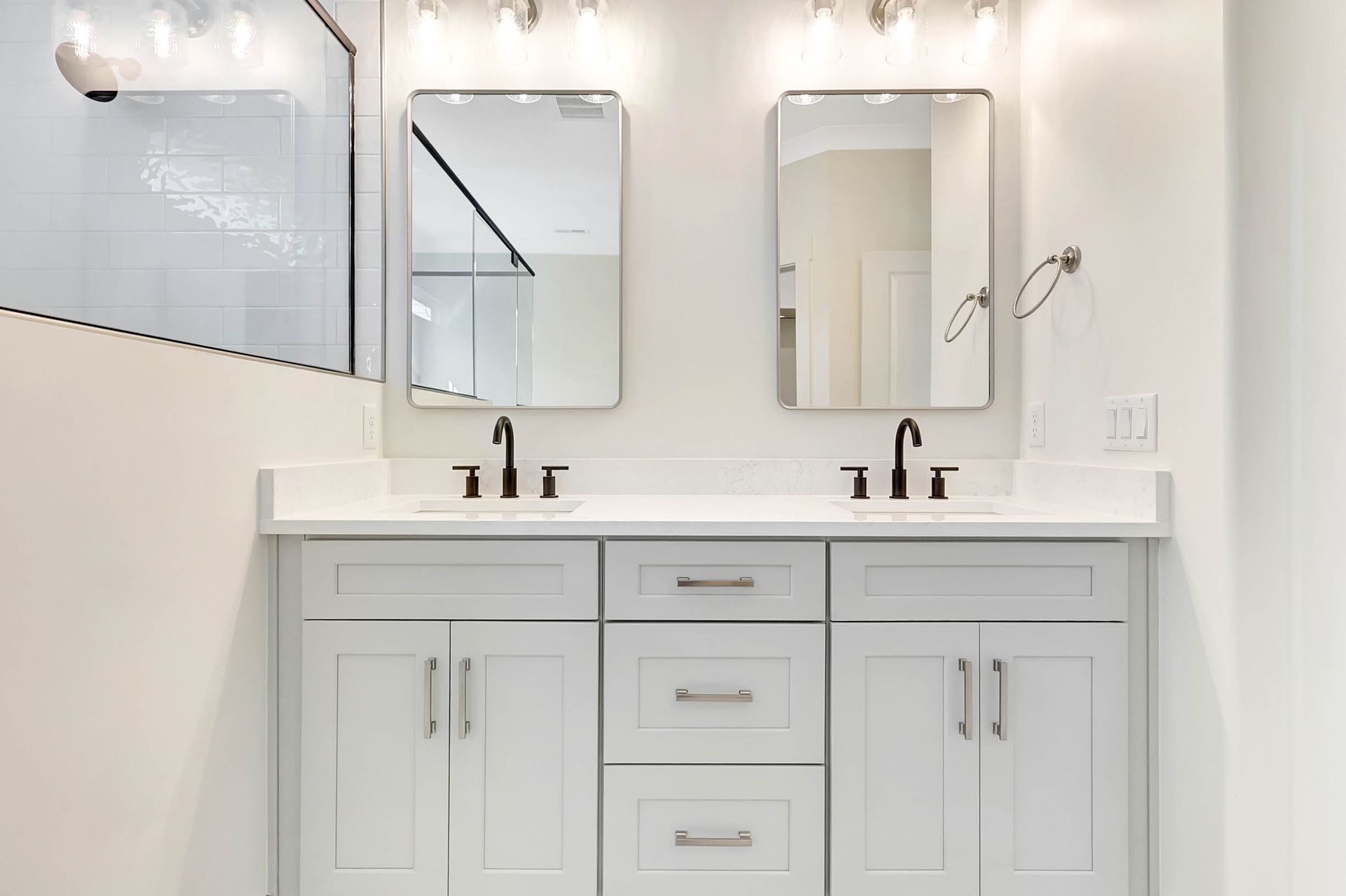 A bathroom with two sinks and two mirrors.
