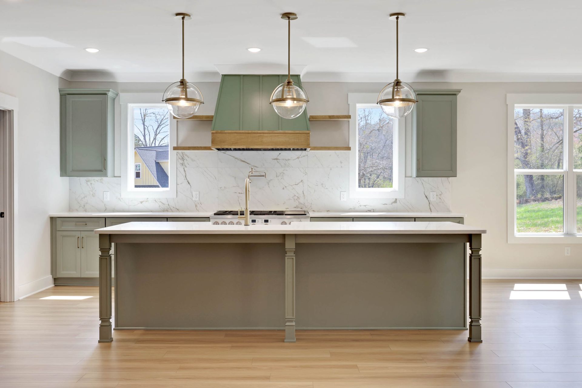 An empty kitchen with a large island in the middle