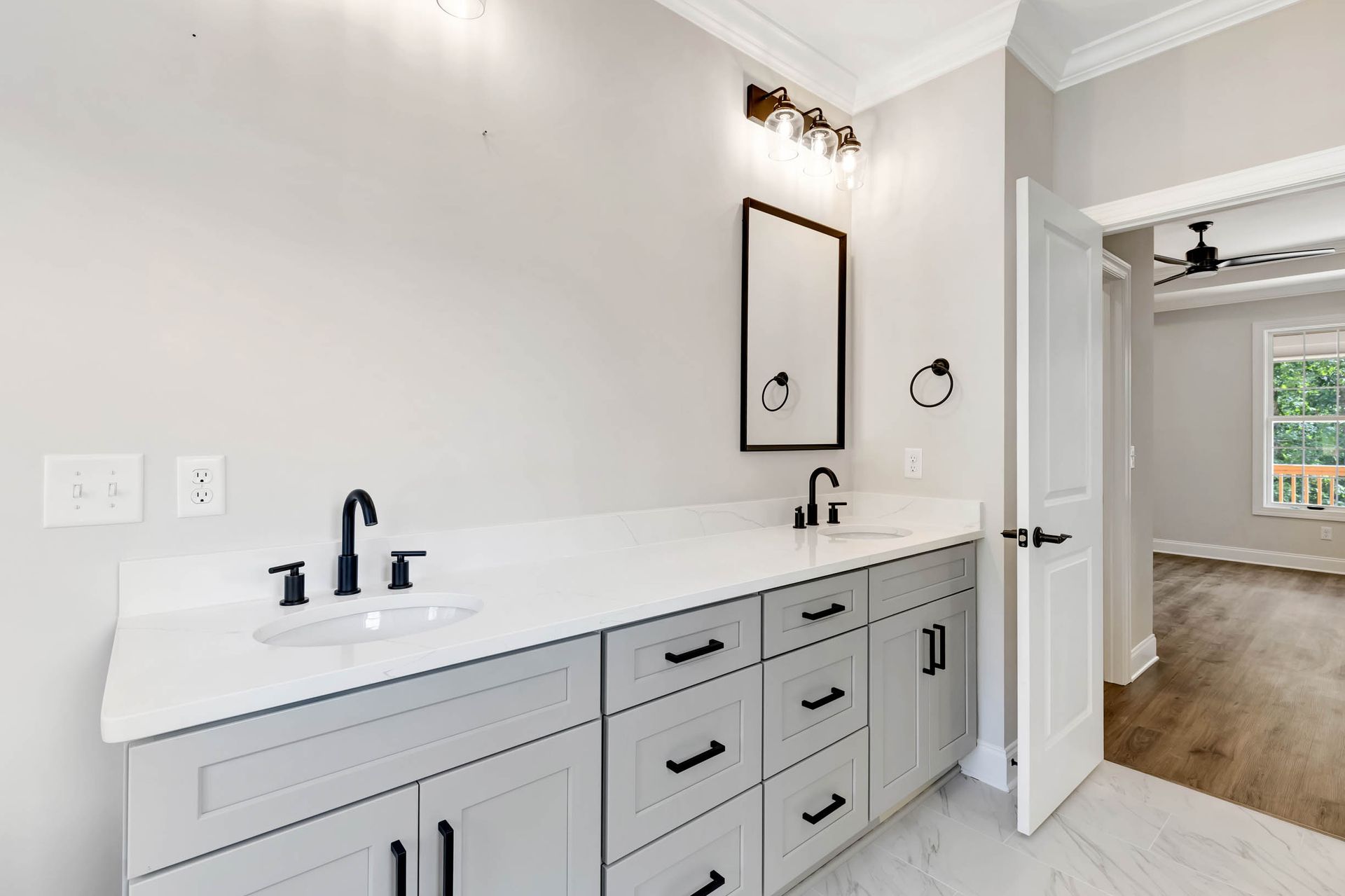 A bathroom with two sinks and a mirror.