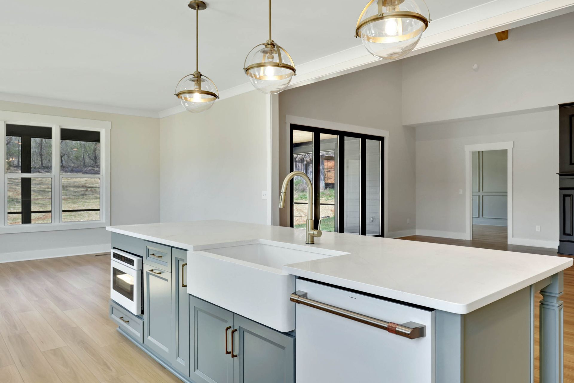 A kitchen with a large island , sink , and dishwasher.