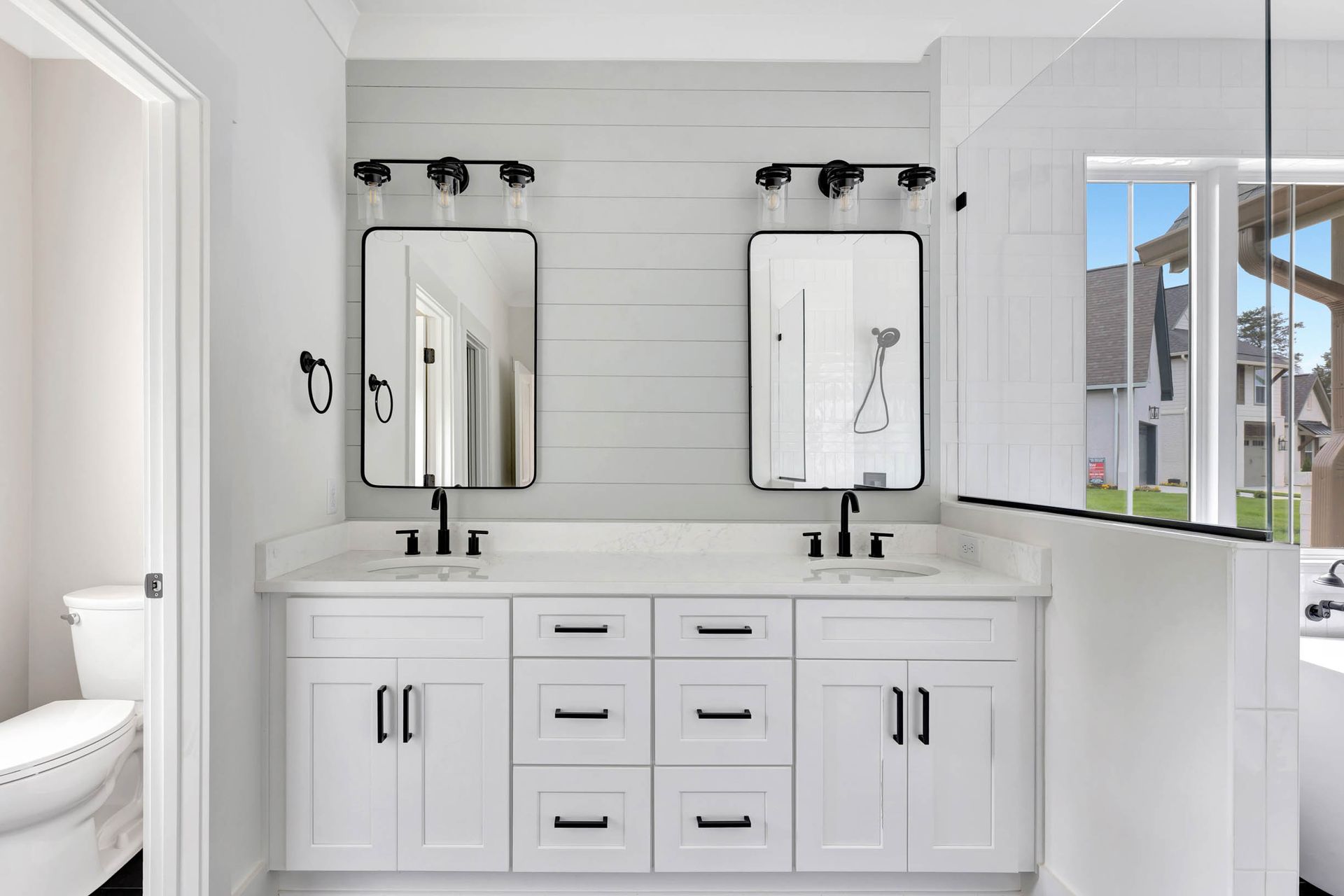 A bathroom with two sinks and two mirrors.