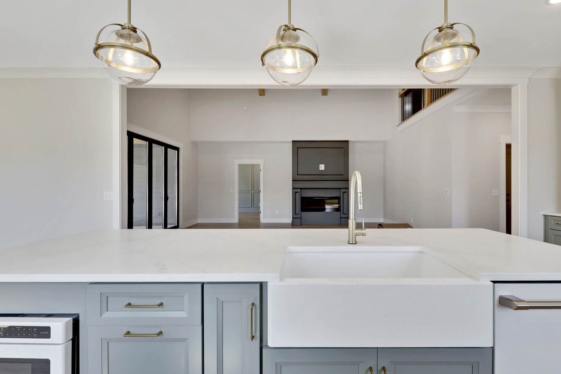 A kitchen with a farmhouse sink and a white counter top.