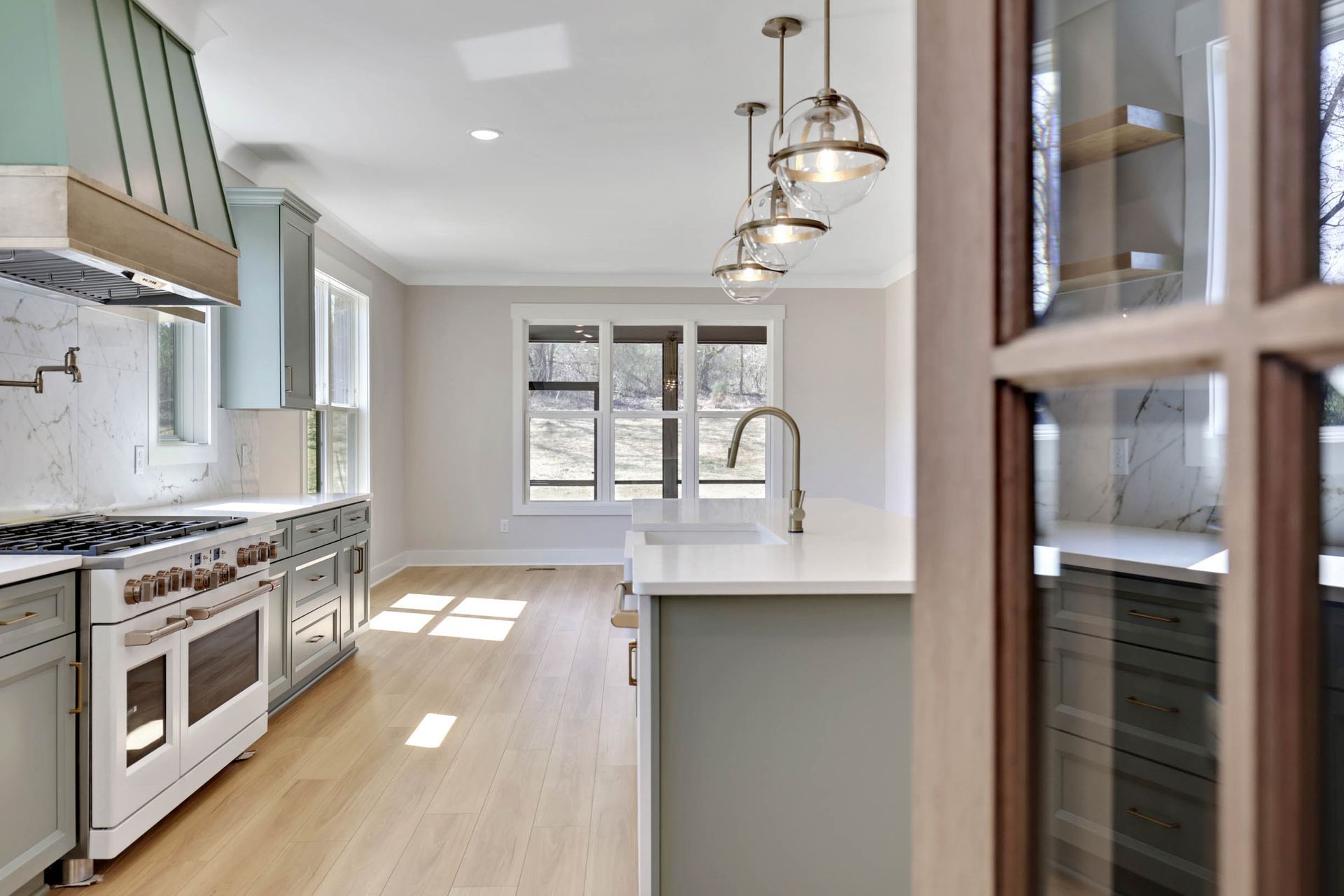 A kitchen with a stove top oven and a sink