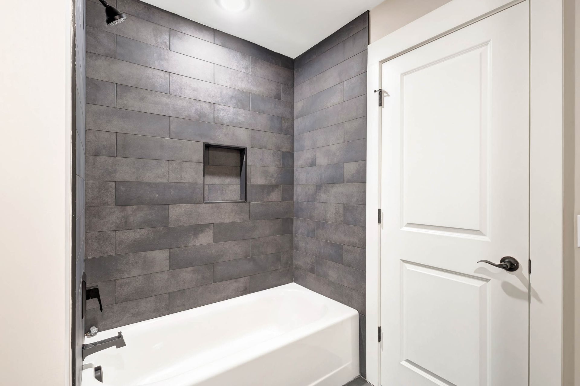 A bathroom with a bathtub and a shower.