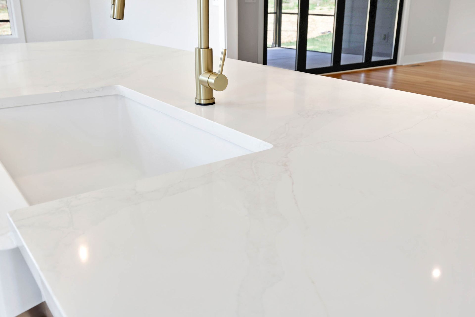 A kitchen counter with a sink and a faucet.