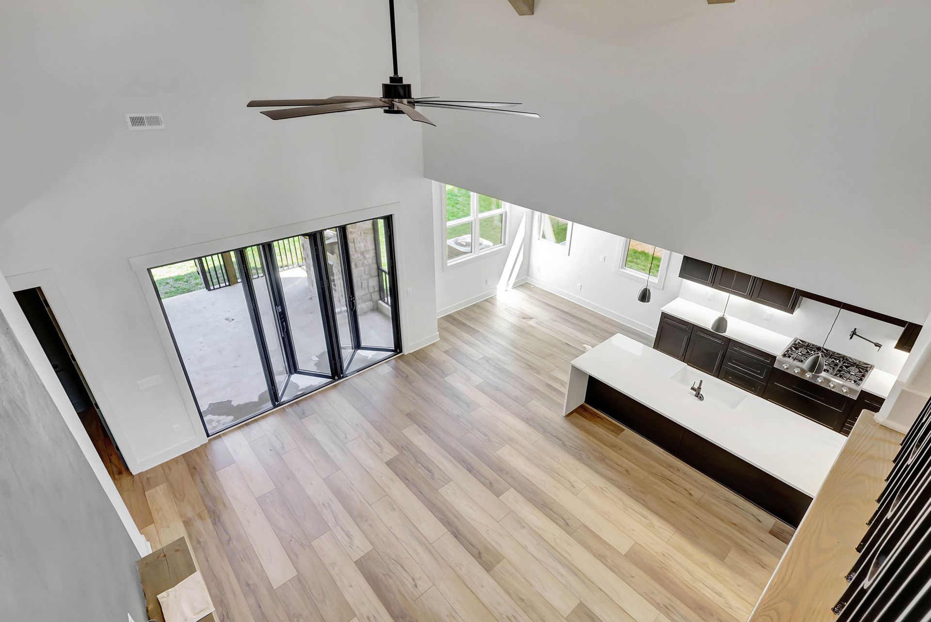 An aerial view of a living room and kitchen in a house.