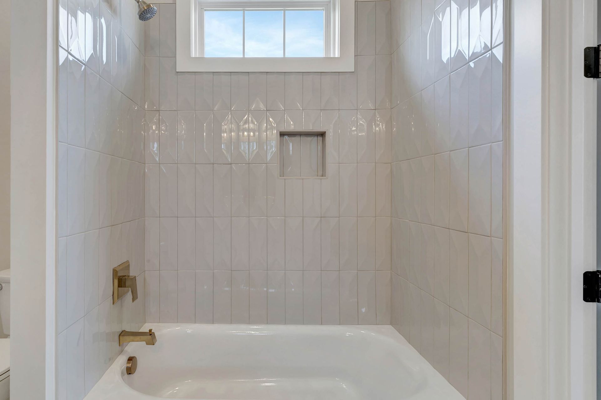 A bathroom with a bathtub and a shower.