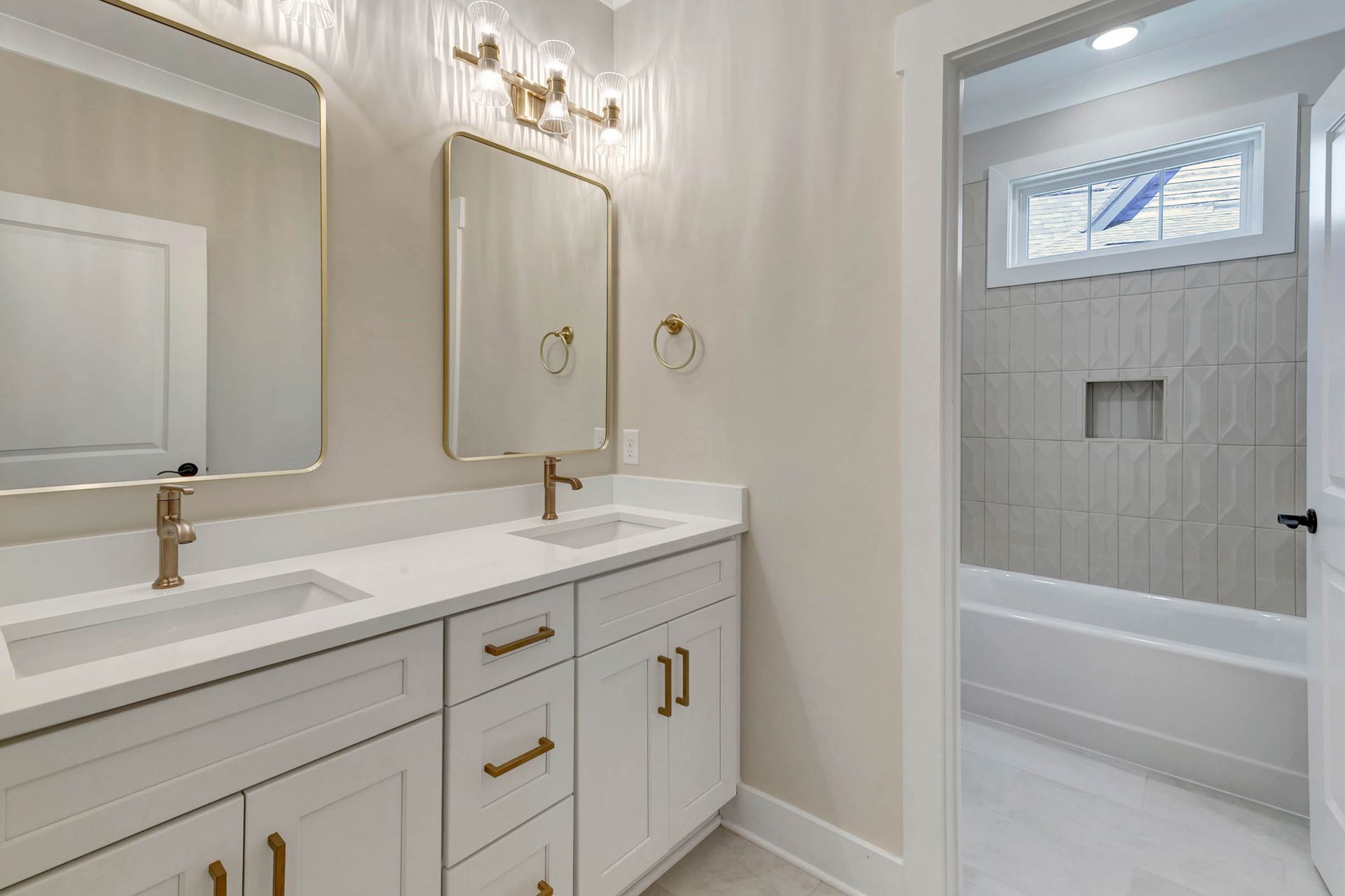 A bathroom with two sinks and two mirrors.