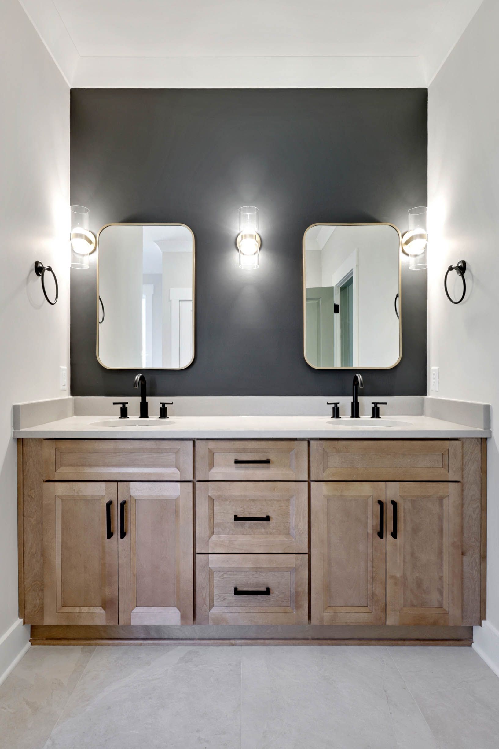 A bathroom with two sinks and two mirrors.