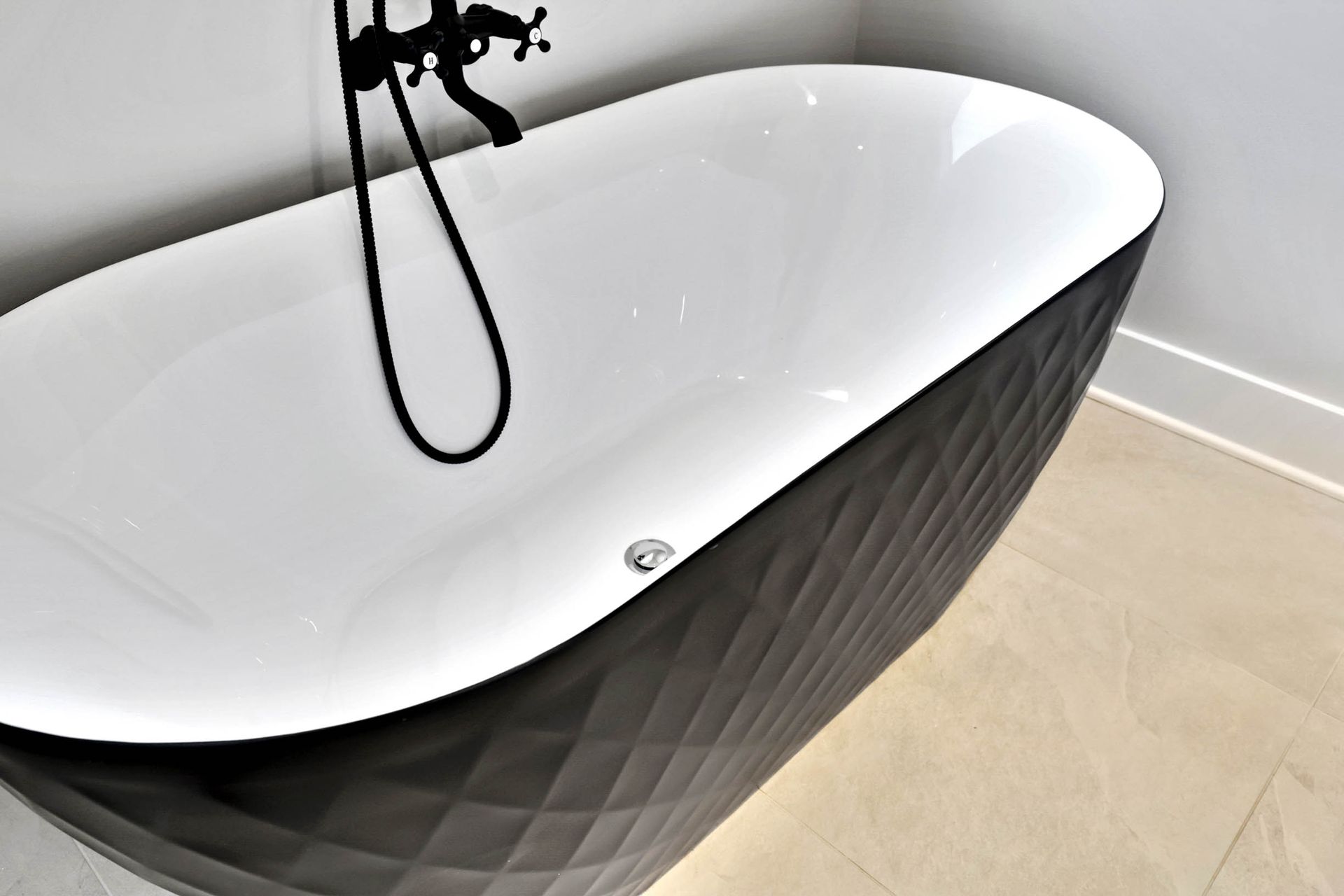 A black and white bathtub with a shower head attached to it