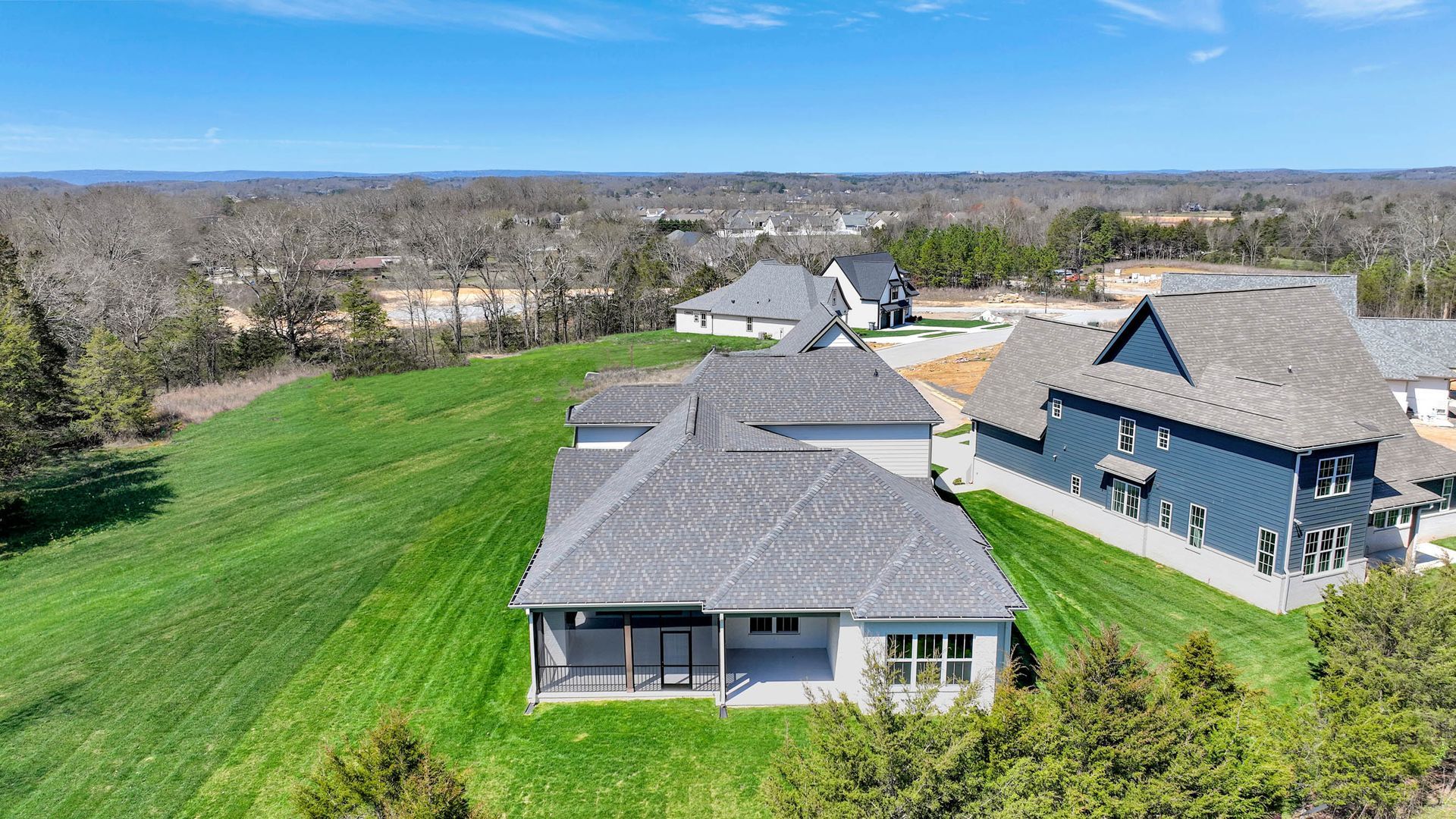 An aerial view of a residential area with houses and trees.
