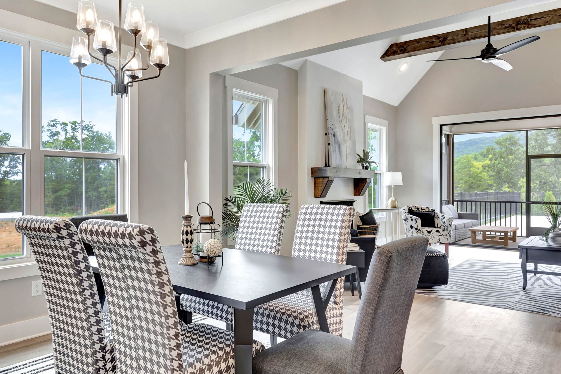 A dining room with a table and chairs and a chandelier.