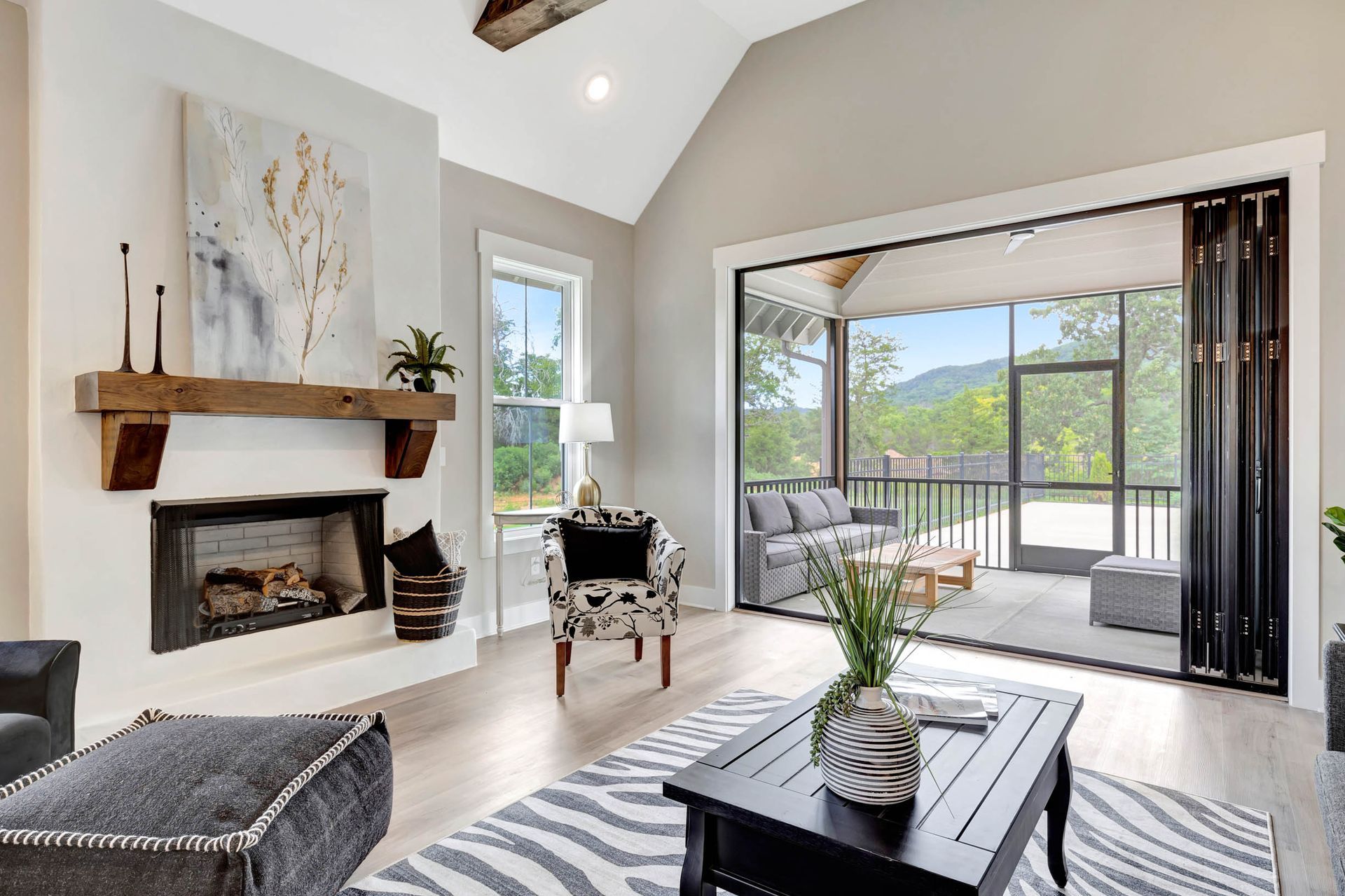 A living room with a fireplace , chairs , and a coffee table.
