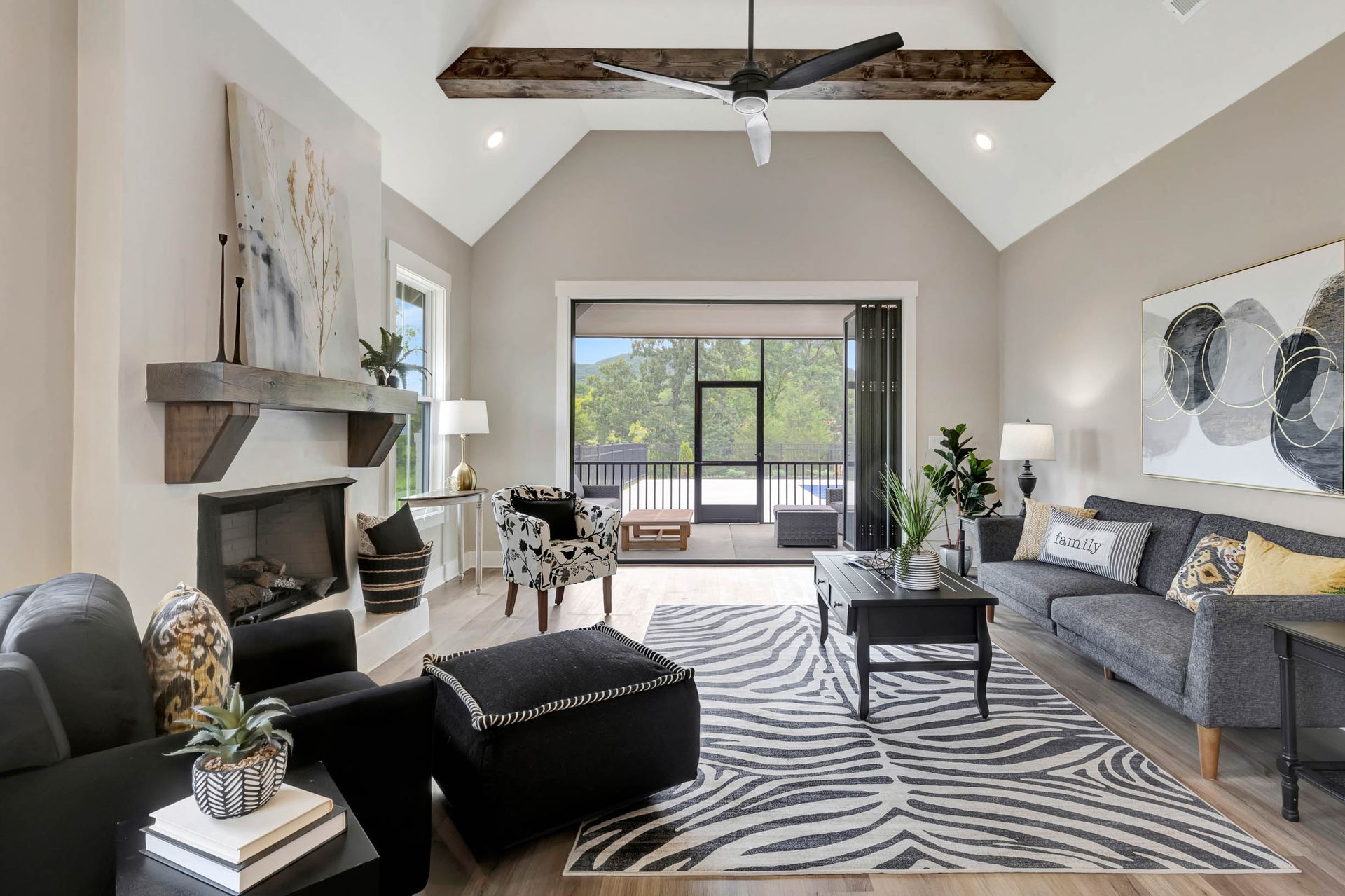A living room filled with furniture and a zebra print rug.
