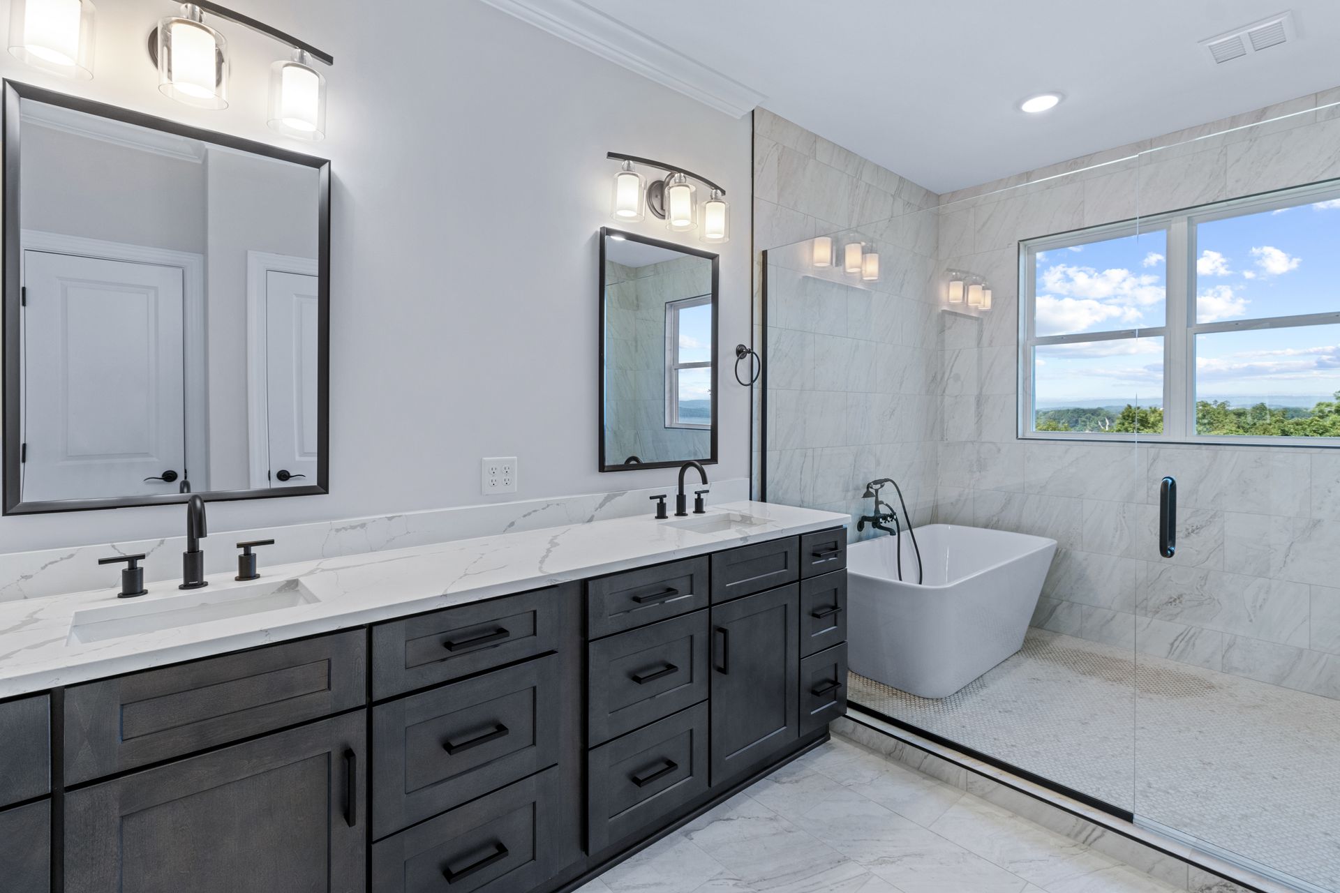 a bathroom with two sinks , two mirrors and a bathtub .