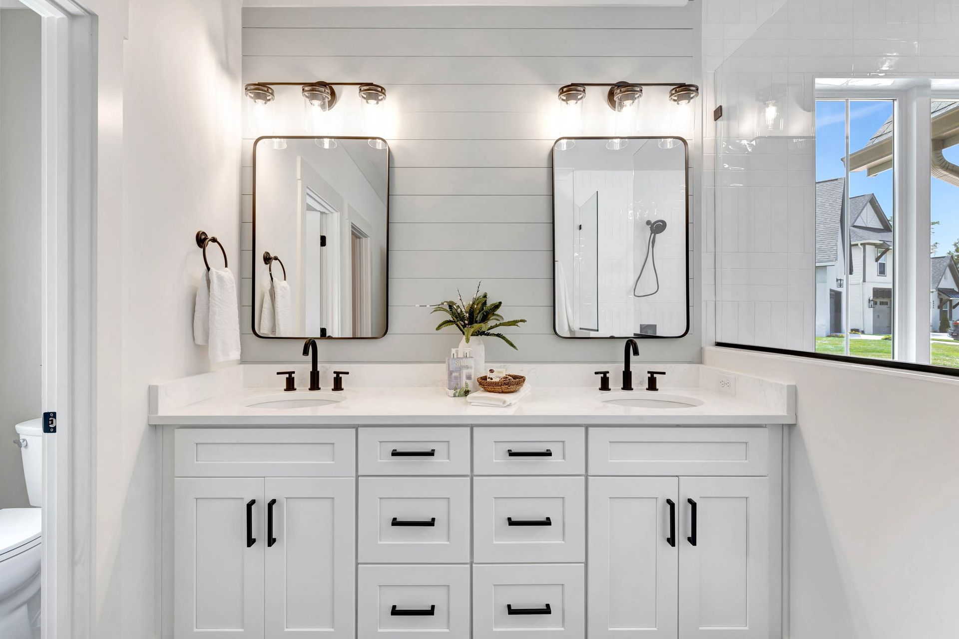 A bathroom with two sinks and two mirrors.