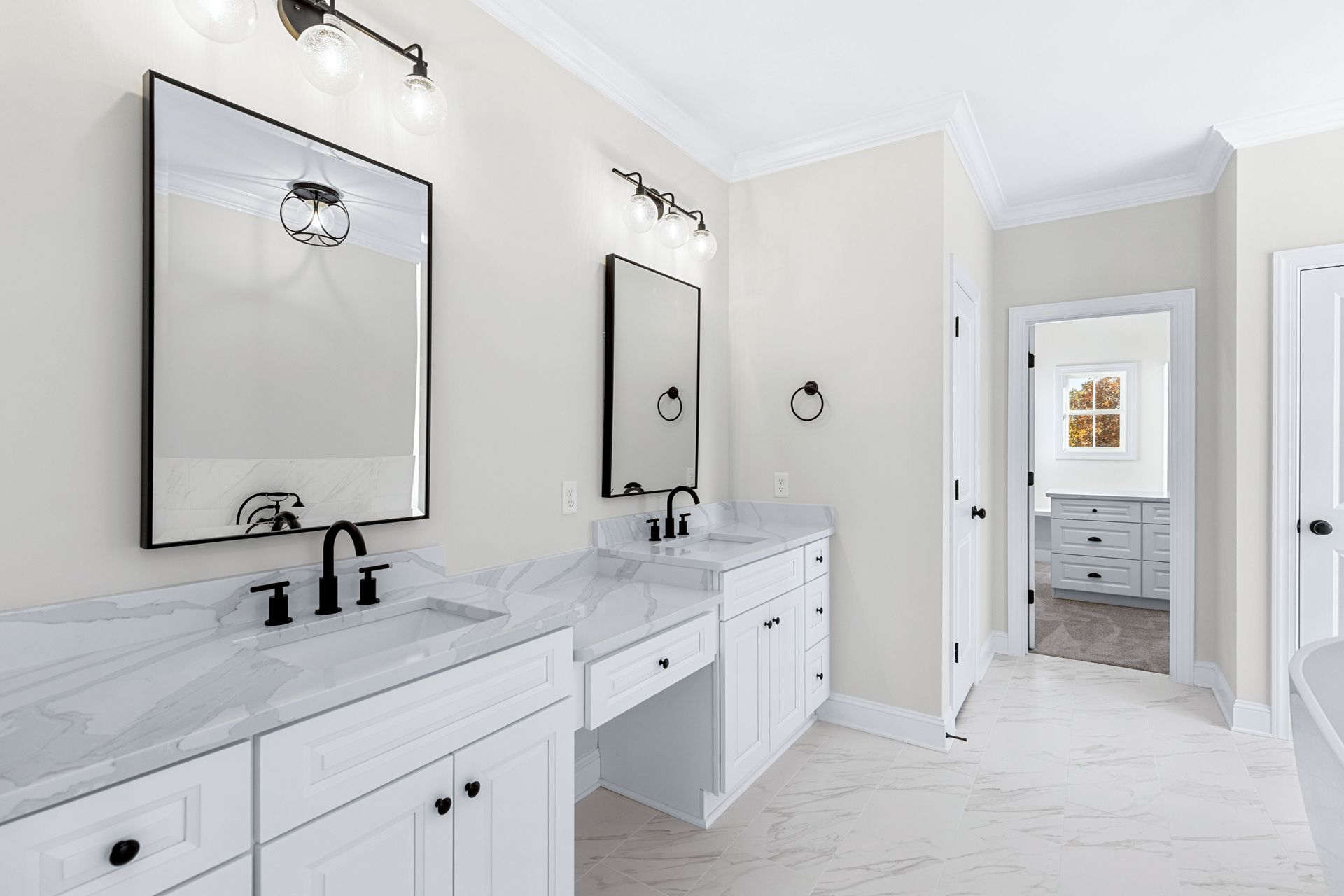 a bathroom with two sinks and two mirrors .