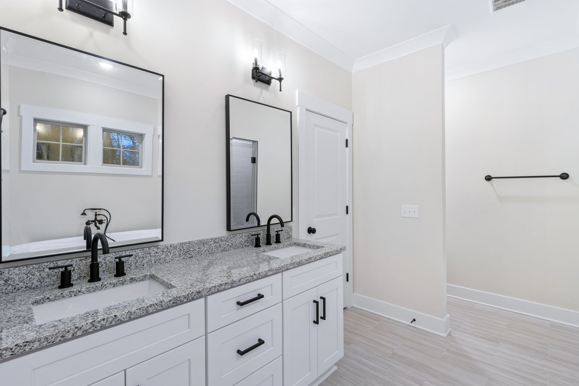 a bathroom with two sinks and two mirrors .