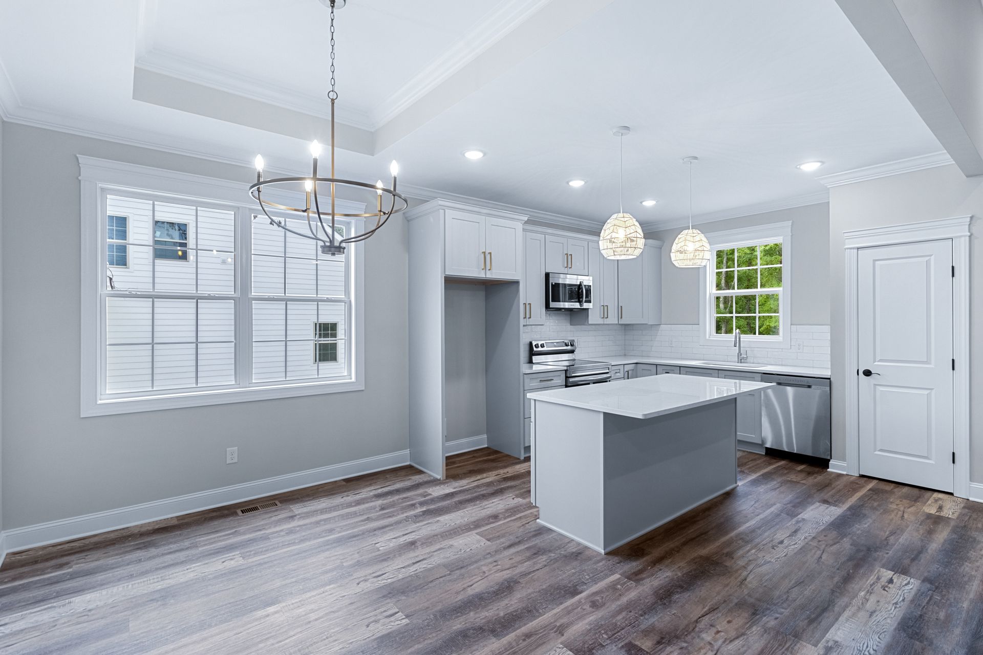 an empty kitchen with a large island in the middle of the room .