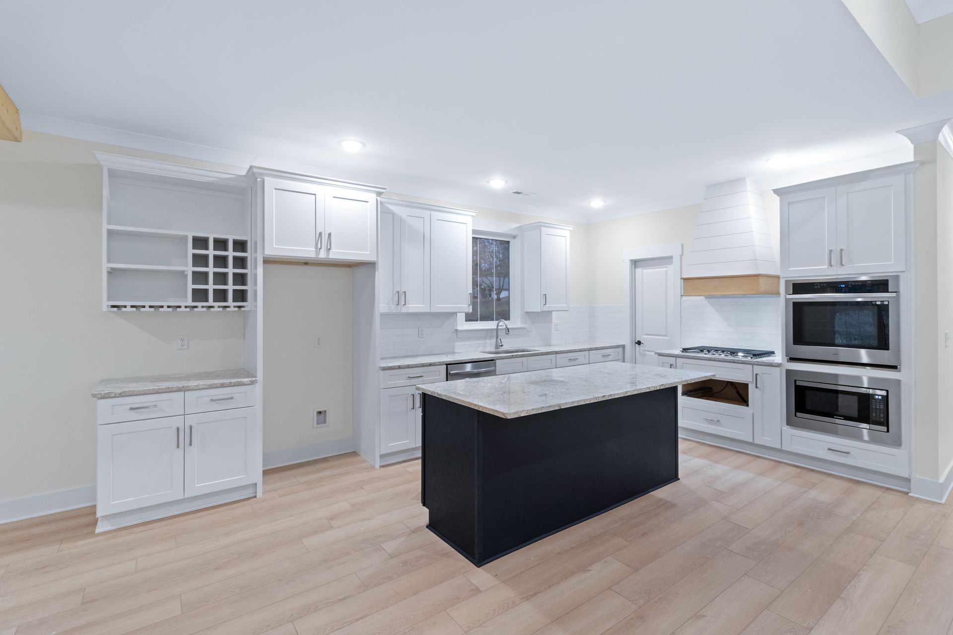 there is a large island in the middle of the kitchen .