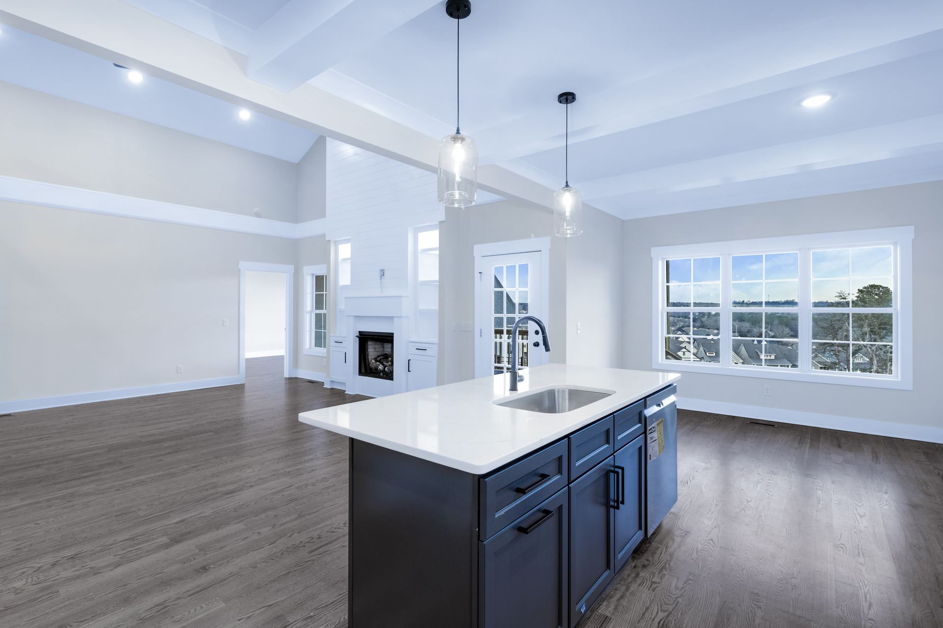 an empty kitchen with a large island in the middle of the room .